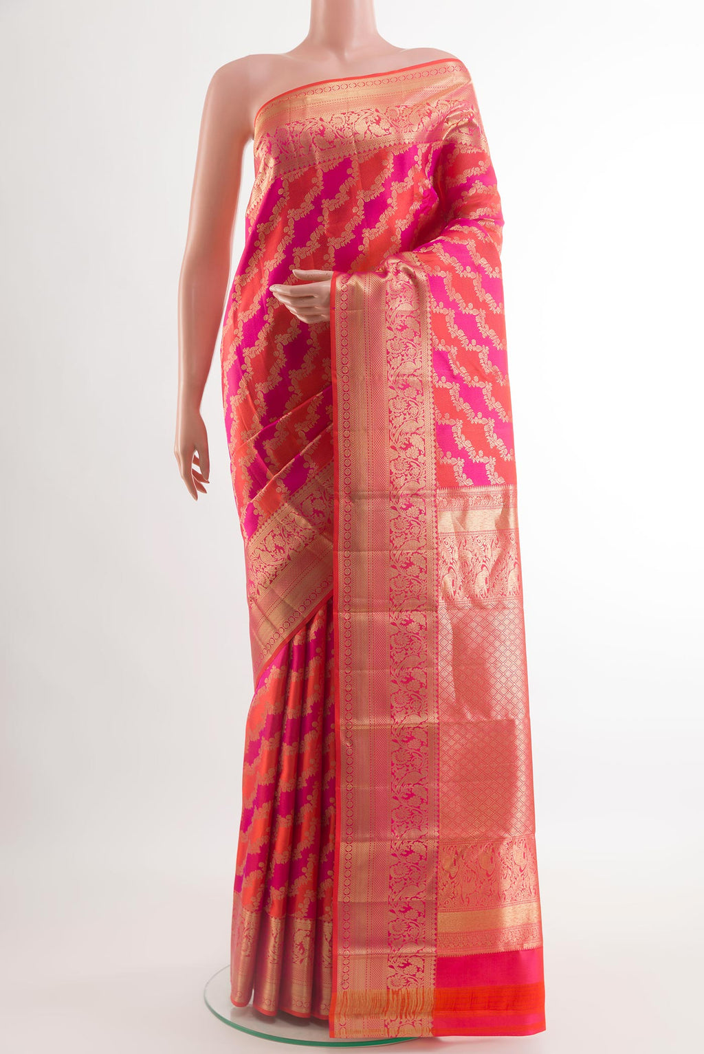 Orange Kanchipuram Silk Saree with Zari Brocade on the body and Paithani Border.  displayed on a mannequin