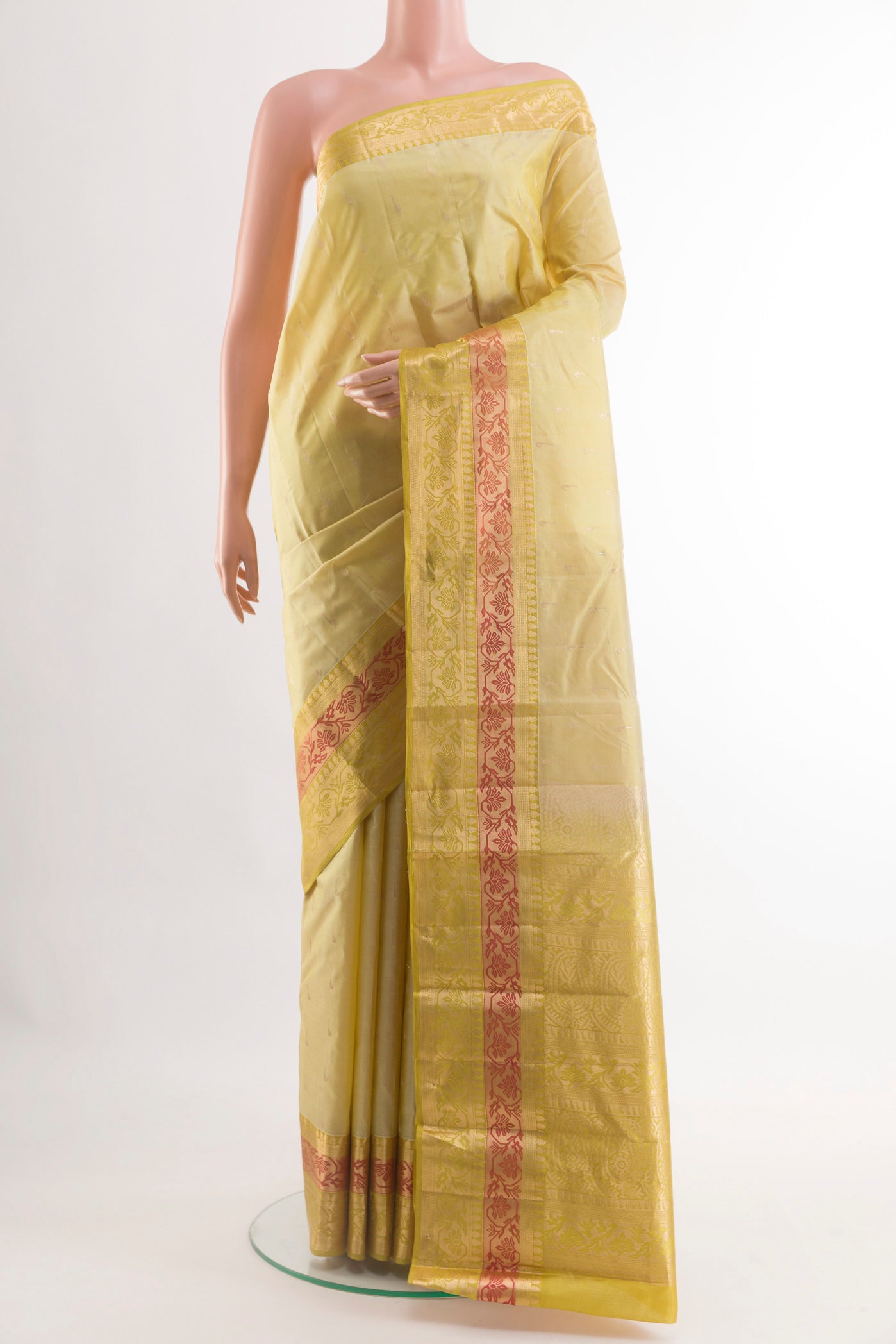 Cream Kanjivaram Silk Saree with Zari Butta on the body and Zari Border.  displayed on a mannequin