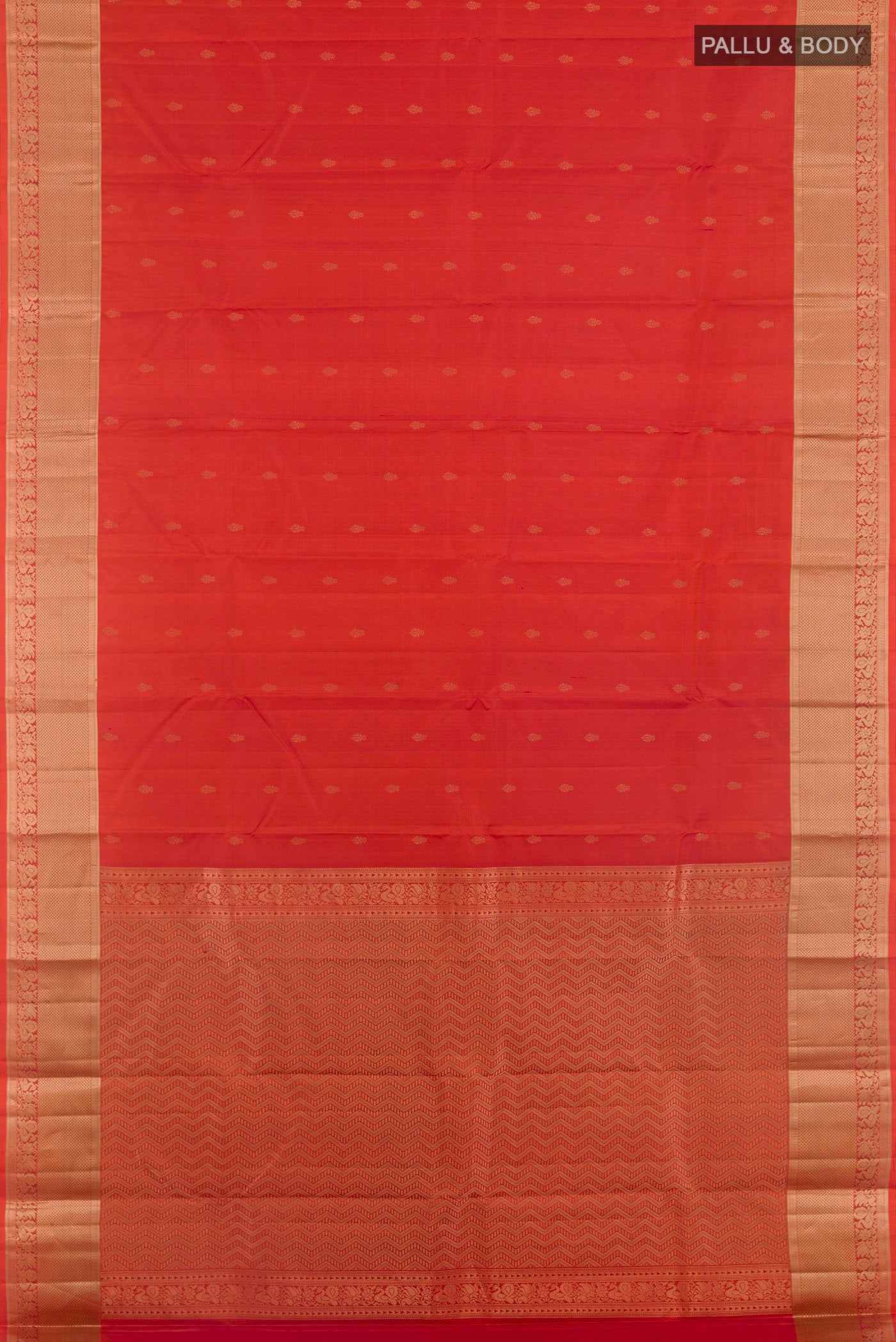 Flat view of Rust Kanjivaram Silk Saree with Zari Butta on the body and Zari Border. 