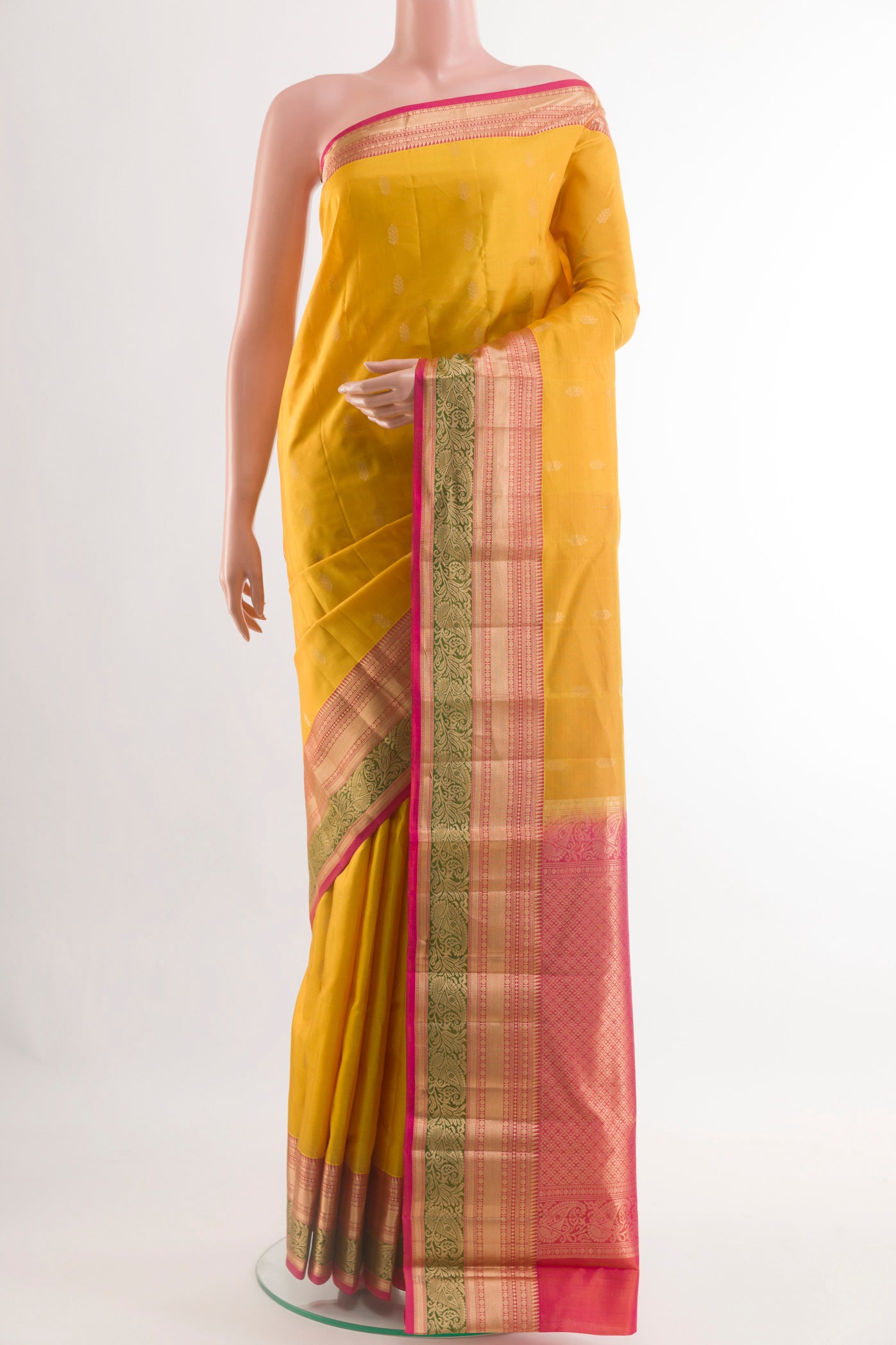 Yellow Kanjivaram Silk Saree with Zari Butta on the body and Zari Border.  displayed on a mannequin