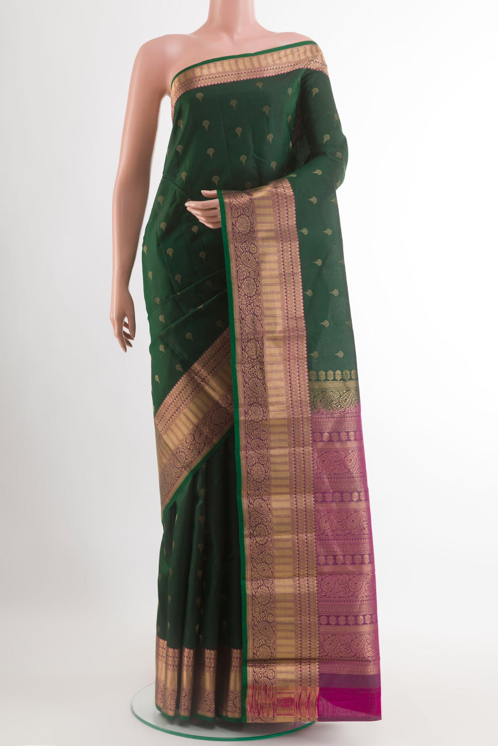 Green Kanjivaram Silk Saree with Zari Butta on the body and Zari Border.  displayed on a mannequin