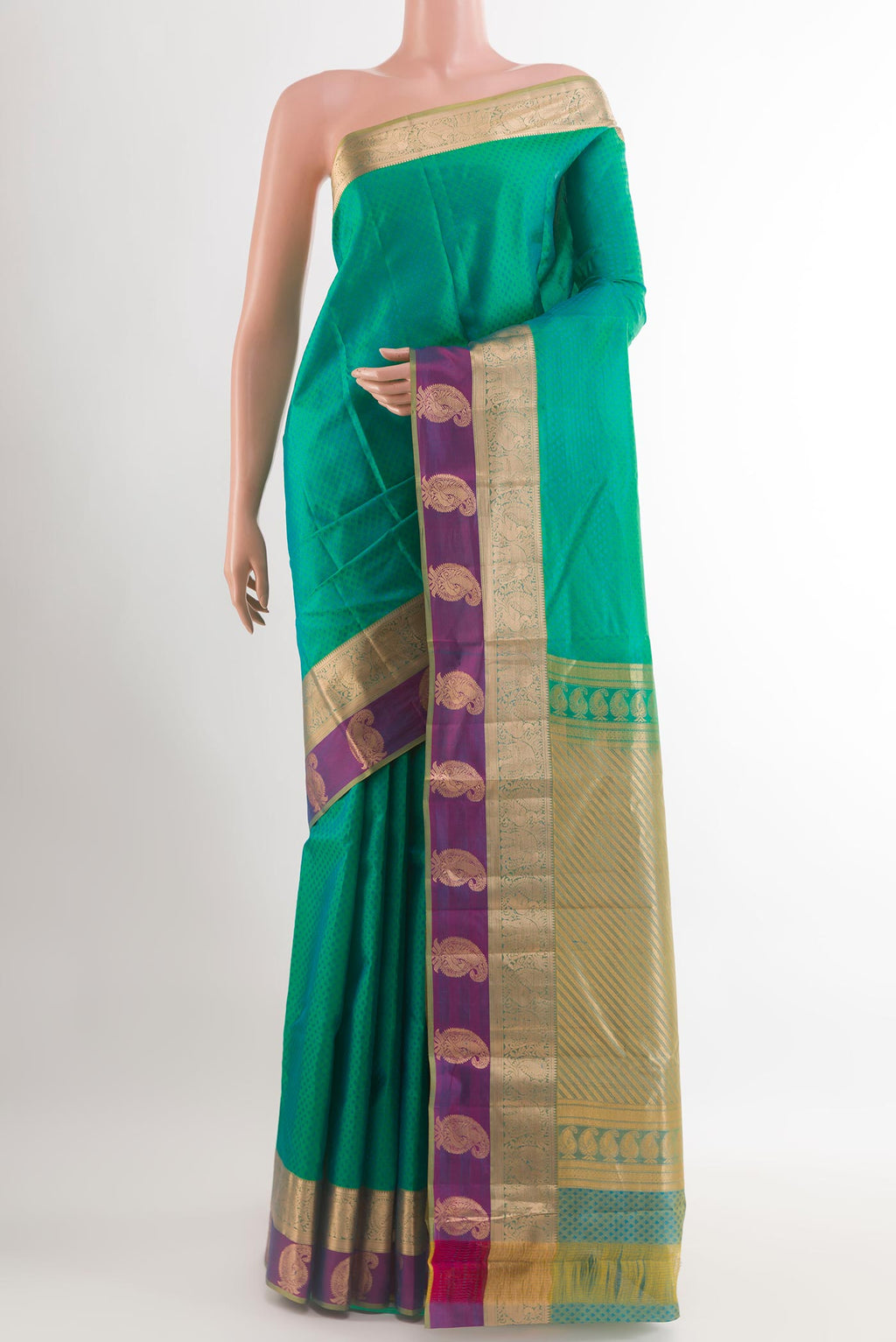 Green Kanjivaram Silk Saree with Jacquard design on the body and Zari Border.  displayed on a mannequin