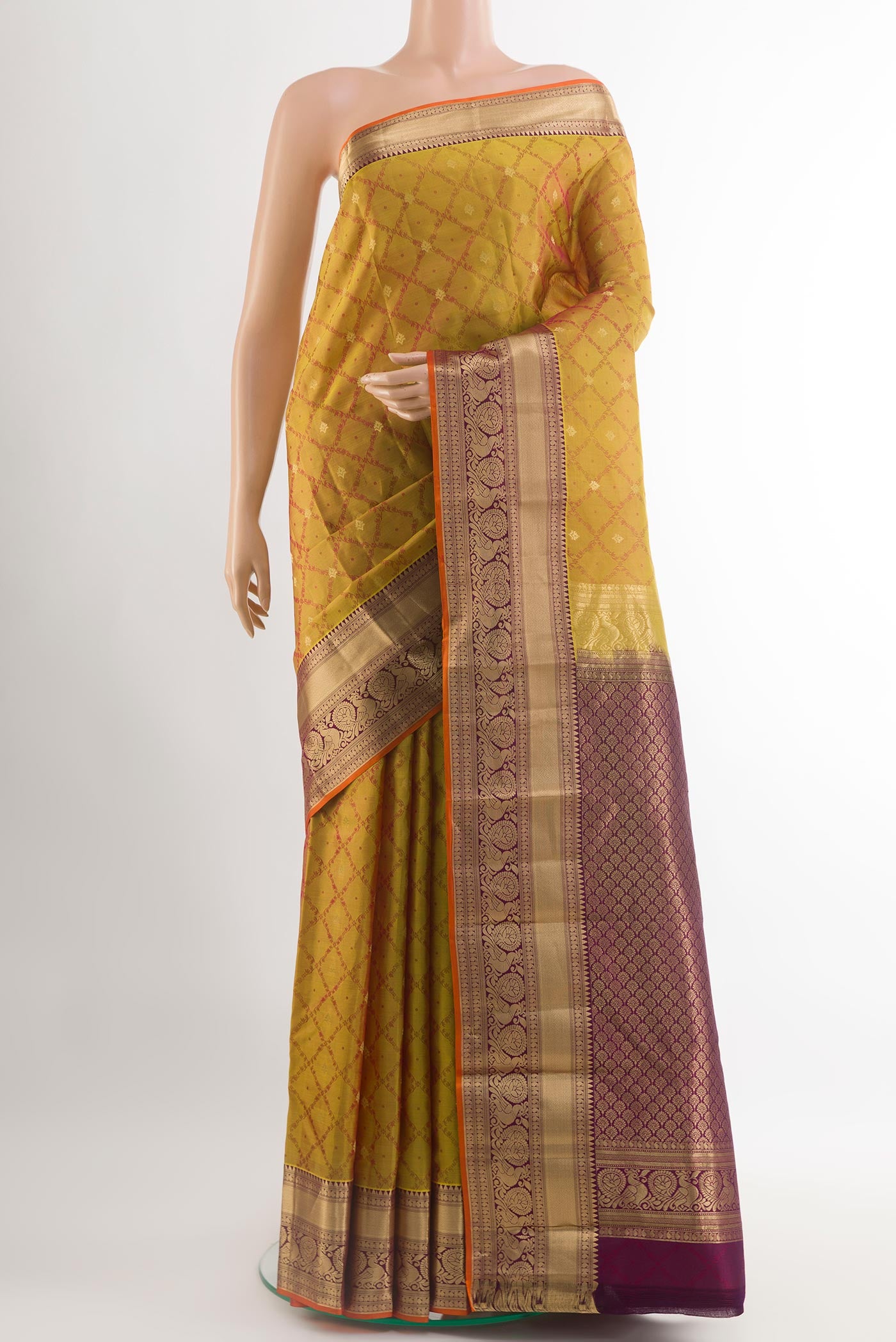 Mustard Kanjivaram Silk Saree with Jacquard With Zari Butta on the body and Zari Border.  displayed on a mannequin