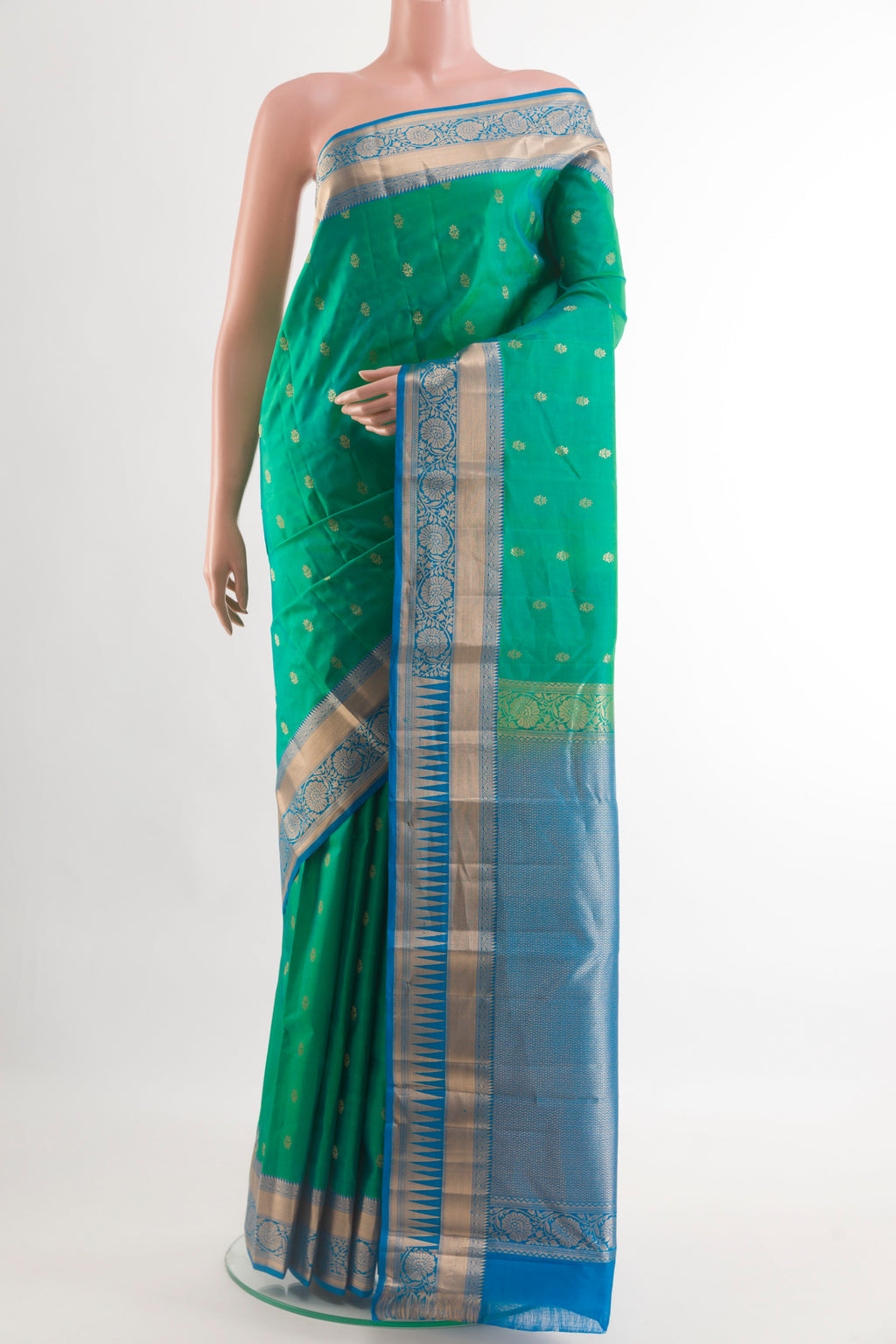 Green Kanjivaram Silk Saree with Zari Butta on the body and Zari Border.  displayed on a mannequin