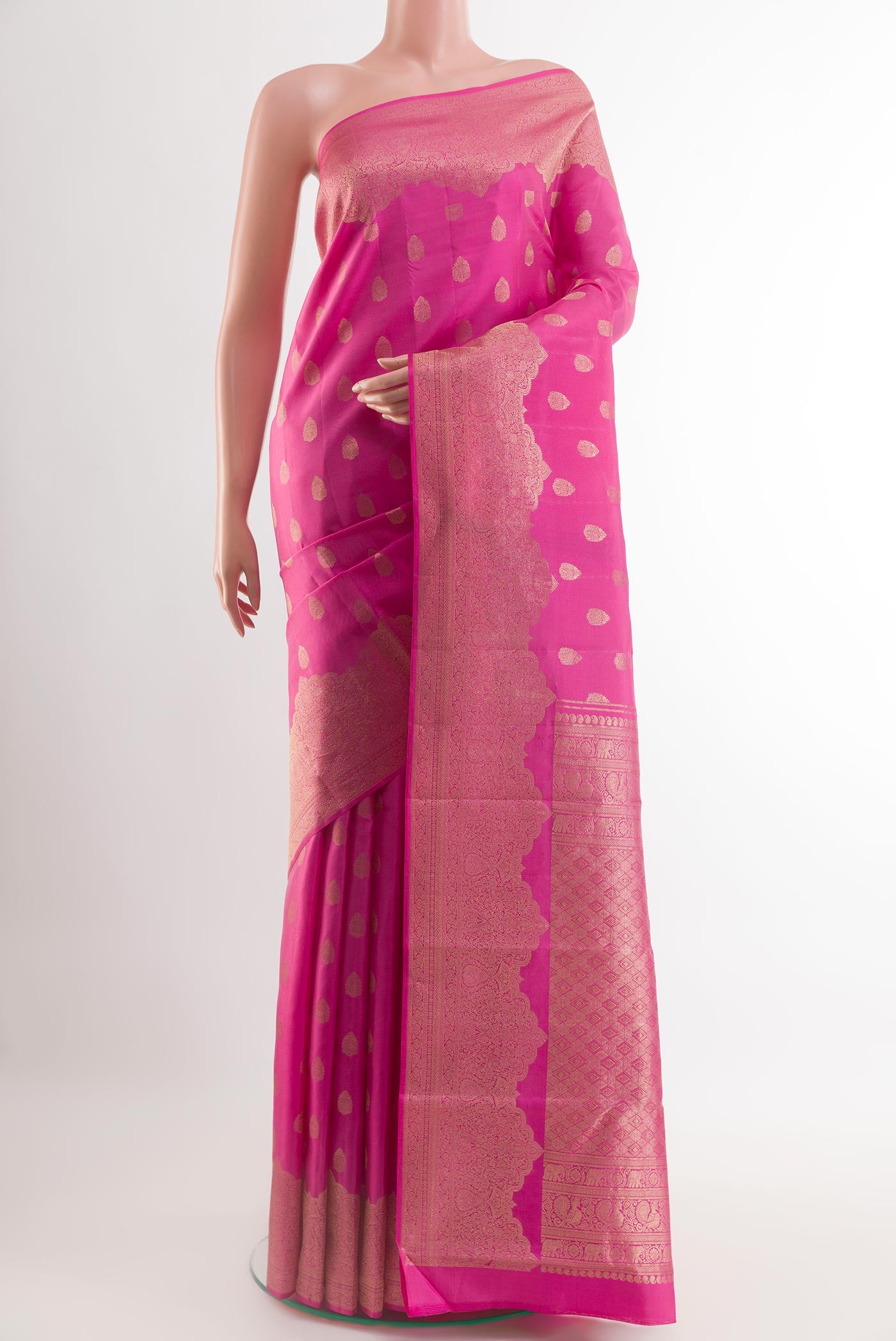 Pink Kanchipuram Silk Saree with Zari Butta on the body and Zari Border.  displayed on a mannequin