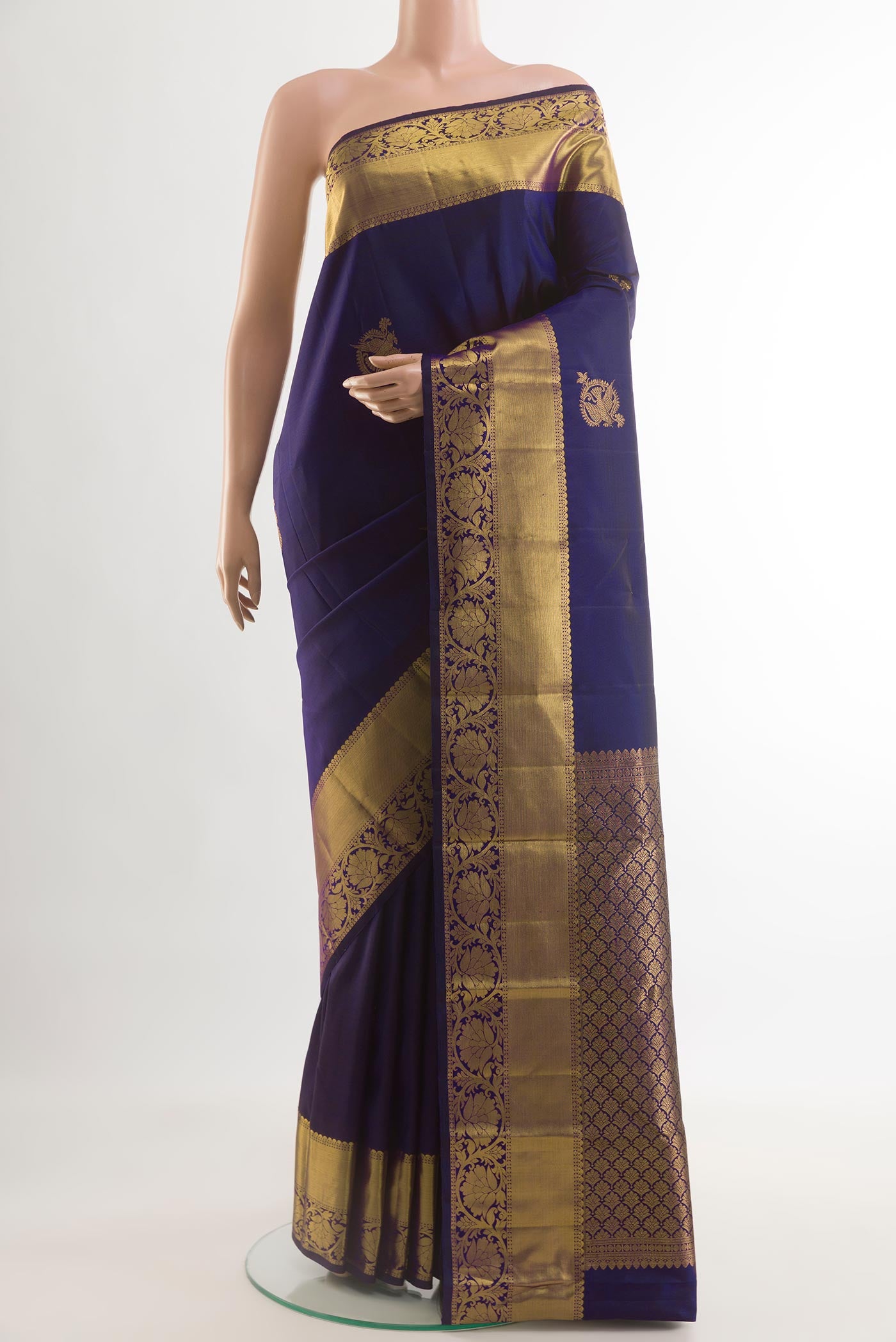 Navy Blue Kanchipuram Silk Saree with Zari Butta on the body and Zari Border.  displayed on a mannequin