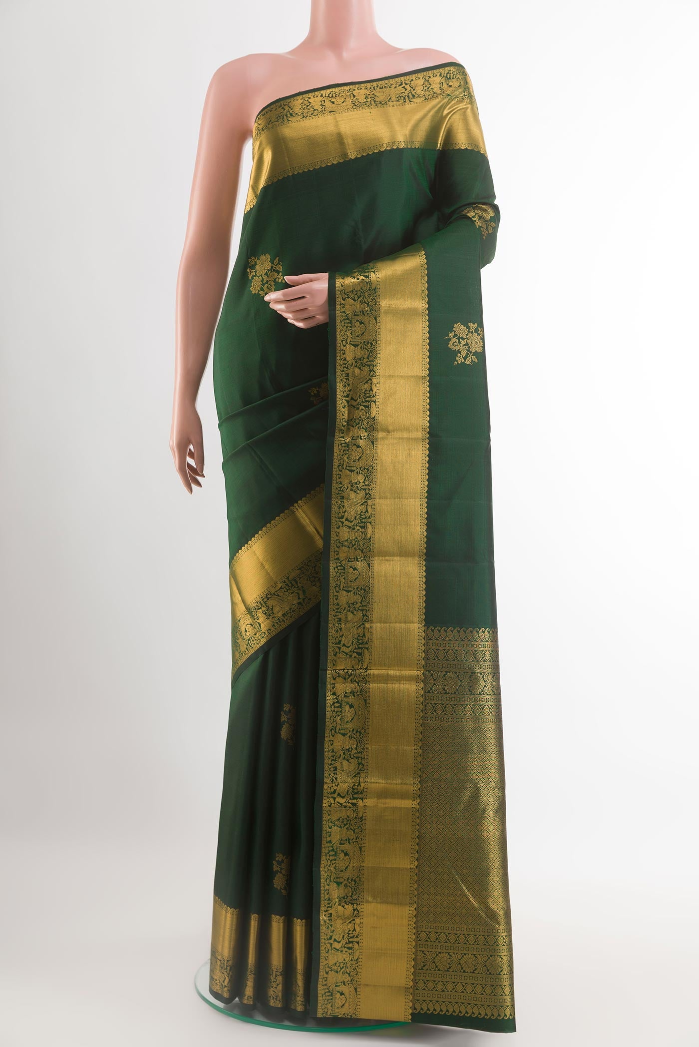 Bottle Green Kanchipuram Silk Saree with Zari Butta on the body and Zari Border.  displayed on a mannequin