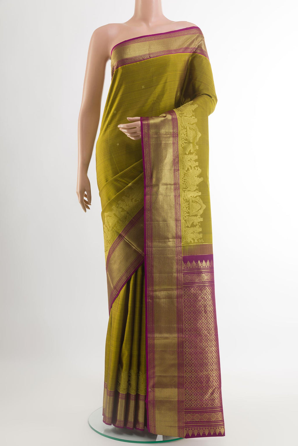 Mustard Kanjivaram Silk Saree with Zari Butta on the body and Zari Border.  displayed on a mannequin