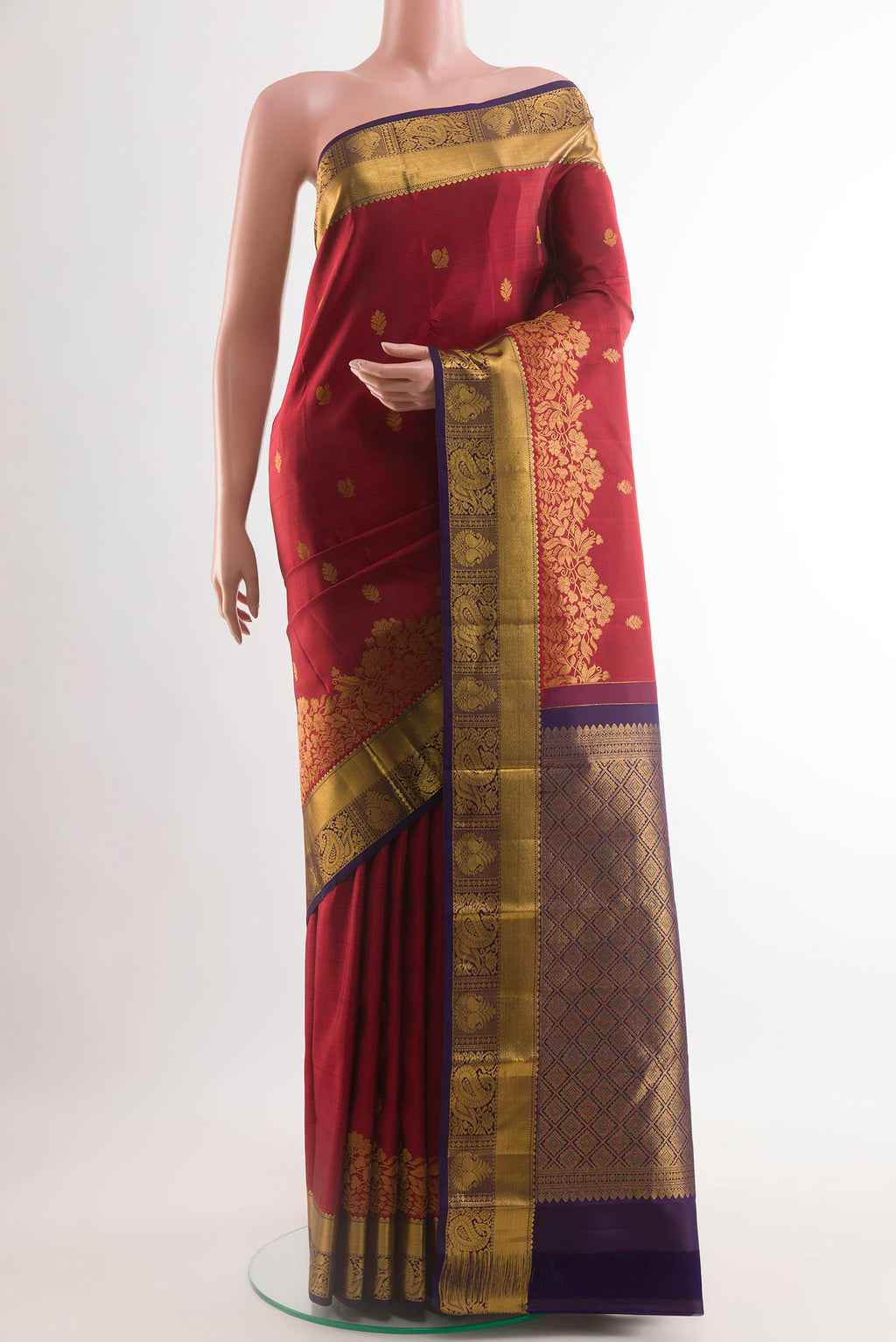Maroon Kanjivaram Silk Saree with Zari Butta on the body and Zari Border.  displayed on a mannequin