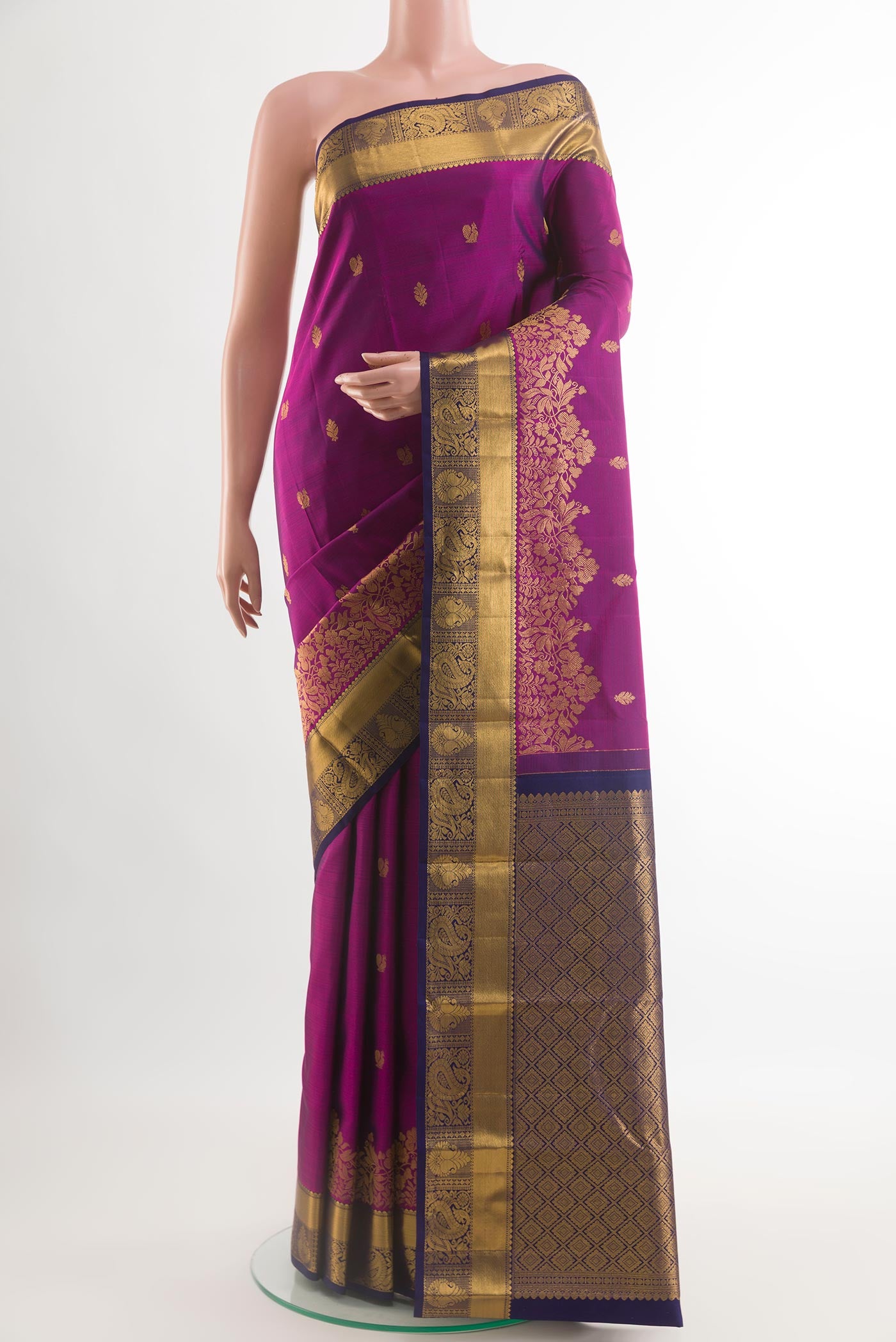 Purple Kanjivaram Silk Saree with Zari Butta on the body and Zari Border.  displayed on a mannequin