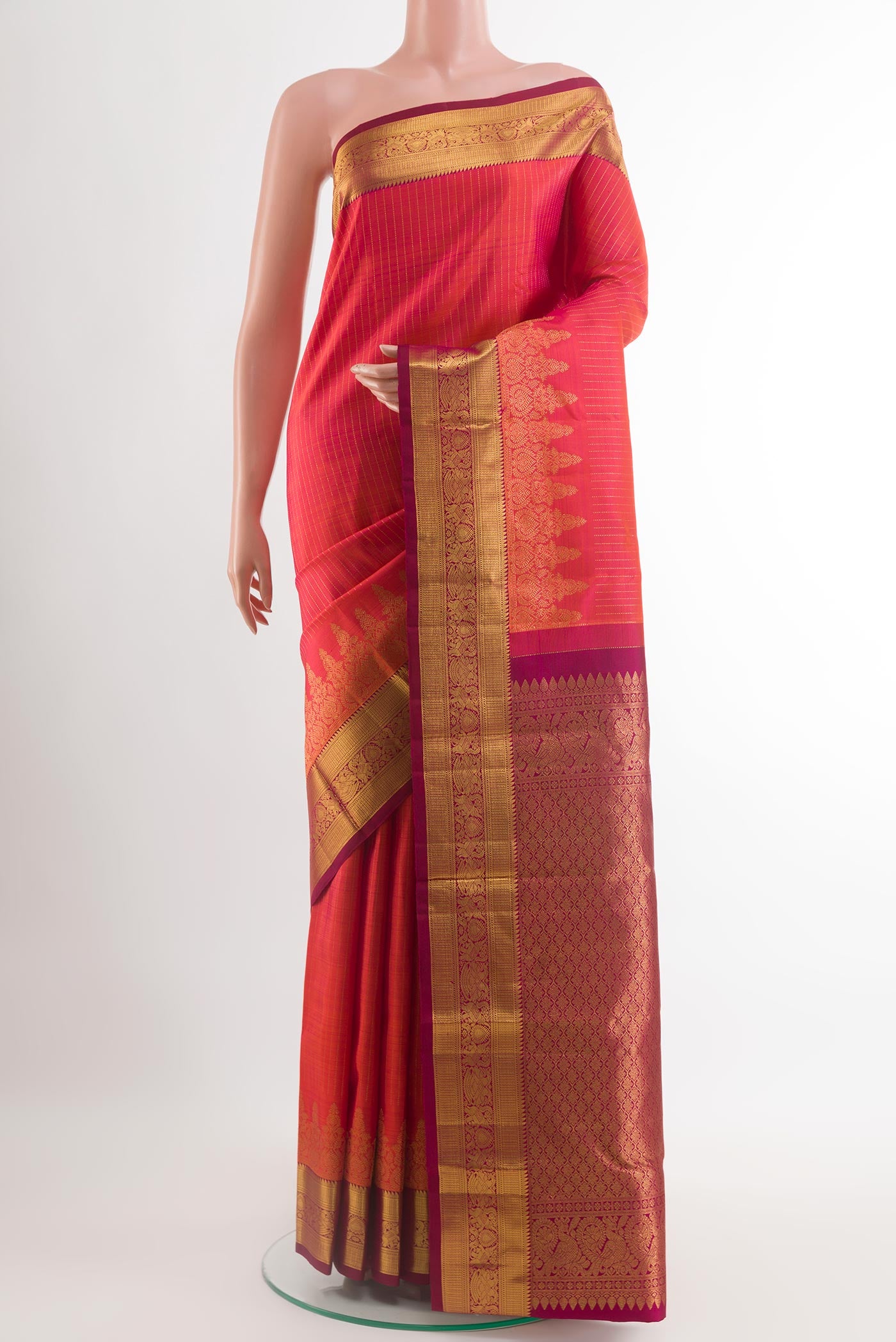 Peach Kanjivaram Silk Saree with Checked design on the body and Zari Border.  displayed on a mannequin