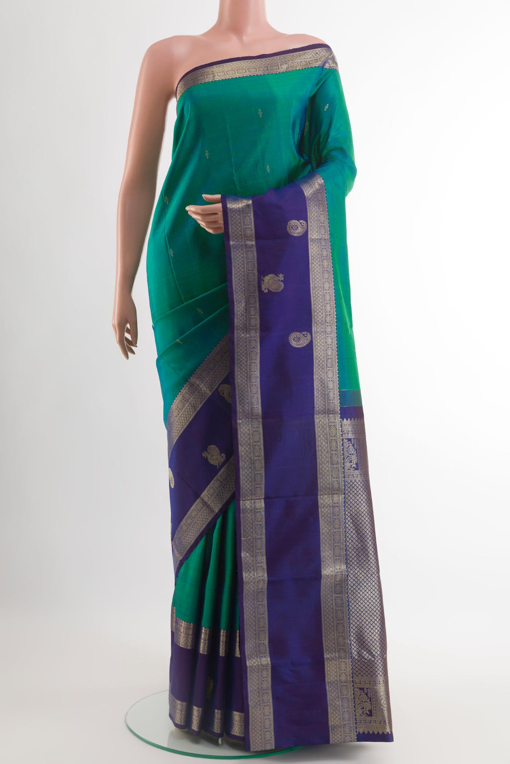 Sea Green Kanjivaram Silk Saree with Zari Butta on the body and Zari Border.  displayed on a mannequin
