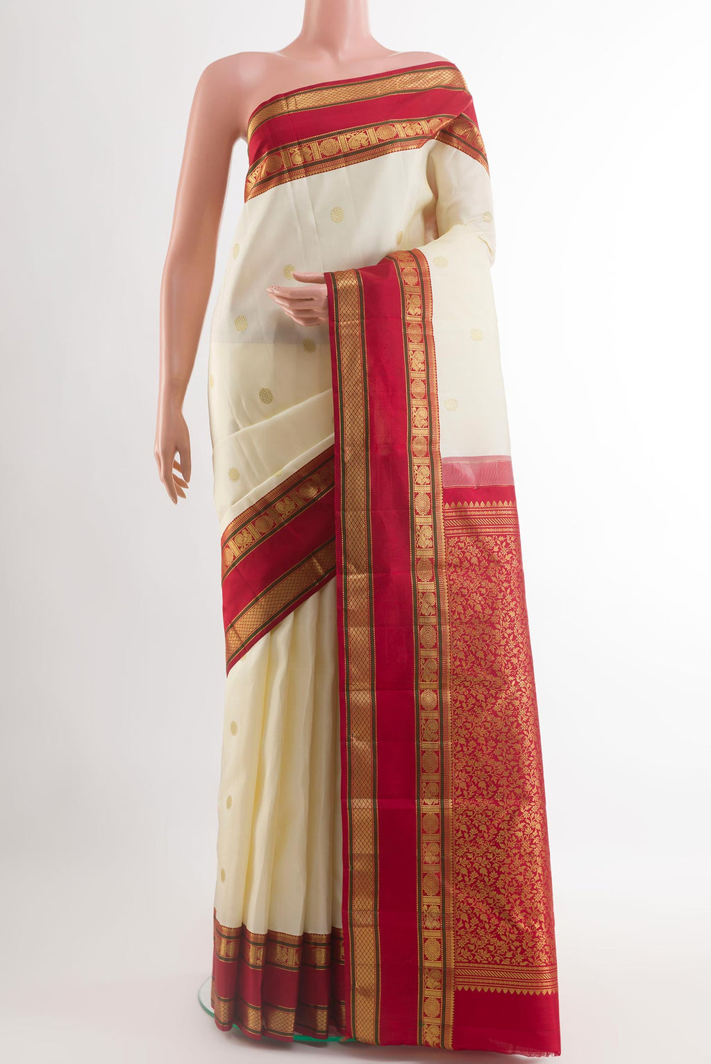 Off White Kanjivaram Silk Saree with Zari Butta on the body and Zari Border.  displayed on a mannequin