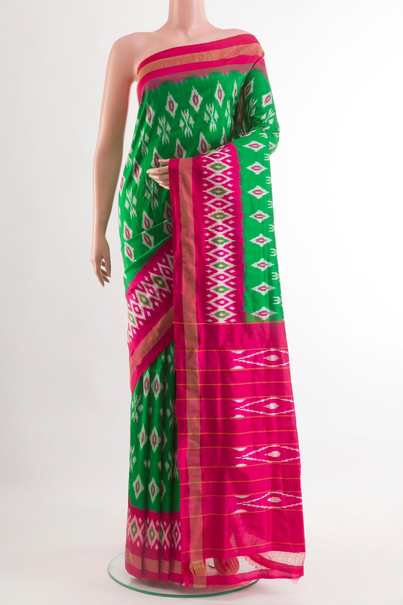 Green Pochampally Silk Saree with Pure Ikat on the body and Zari Border.  displayed on a mannequin