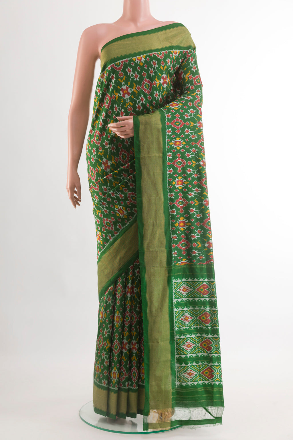 Green Pochampally Silk Saree with Pure Ikat on the body and Zari Border.  displayed on a mannequin