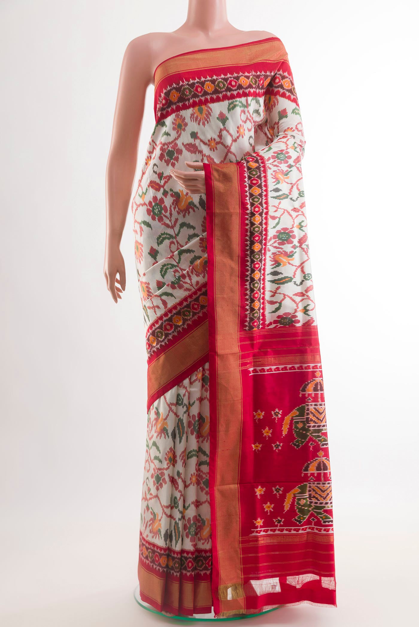 Off White Pochampally Silk Saree with Ikat design on the body and Zari Border.  displayed on a mannequin