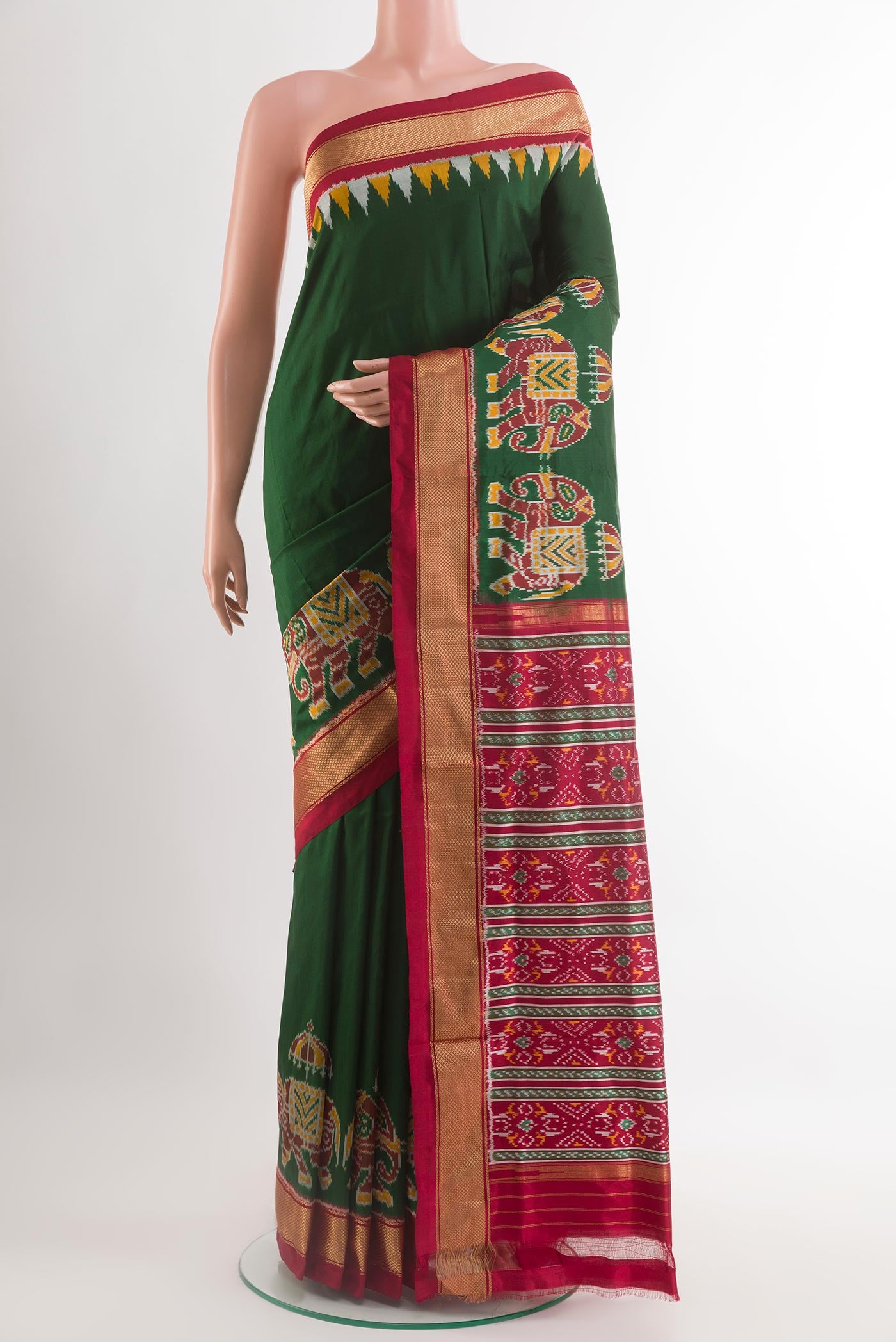 Green Pochampally Silk Saree with Ikat design on the body and Zari Border.  displayed on a mannequin
