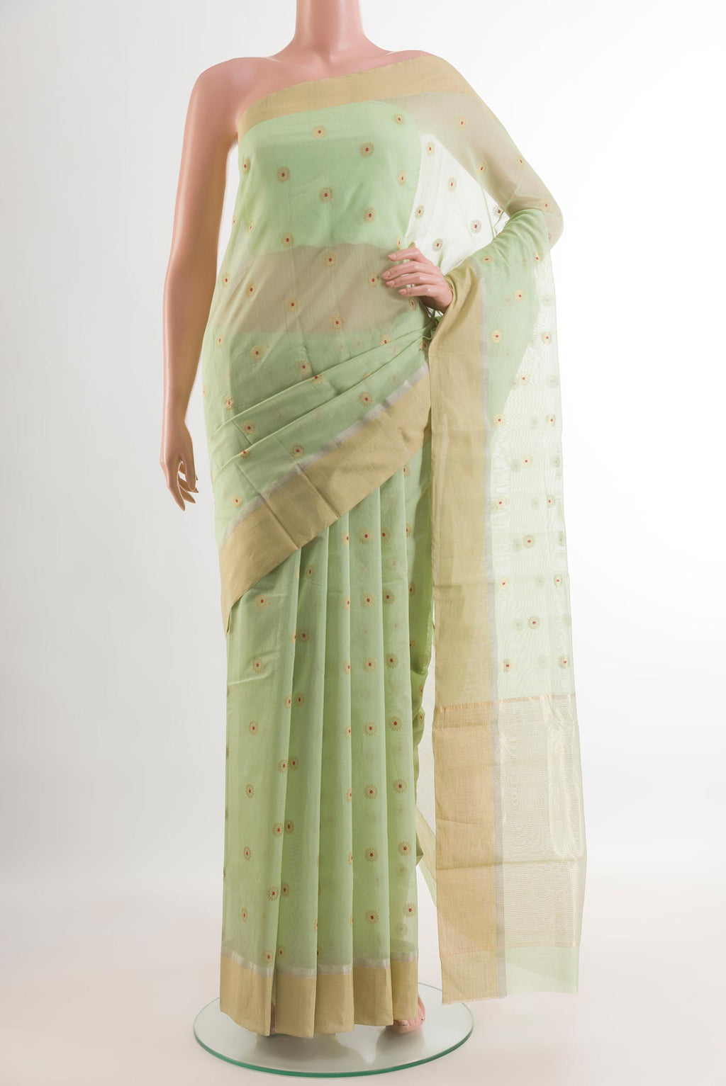 Pista Green Chanderi Silk Cotton Saree with Zari And Thread Butta on the body and Zari Border.  displayed on a mannequin