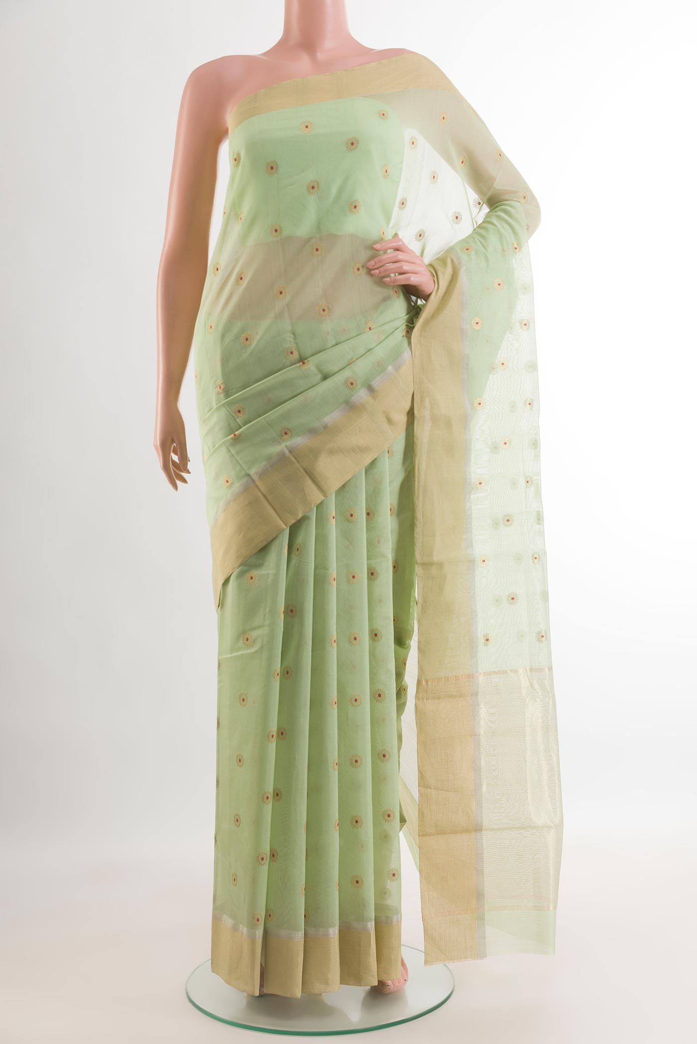 Pista Green Chanderi Silk Cotton Saree with Zari And Thread Butta on the body and Zari Border.  displayed on a mannequin