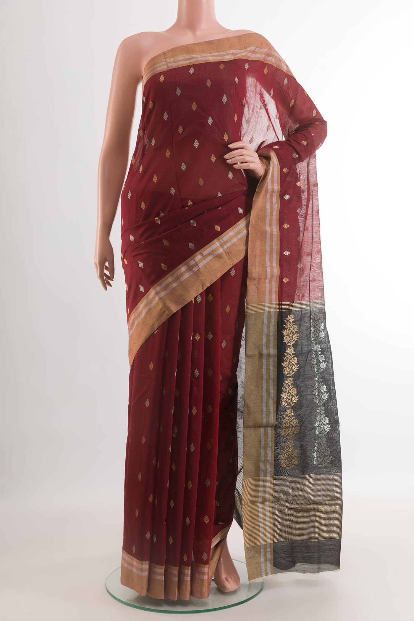 Maroon Chanderi Silk Cotton Saree with Zari Butta on the body and Zari Border.  displayed on a mannequin