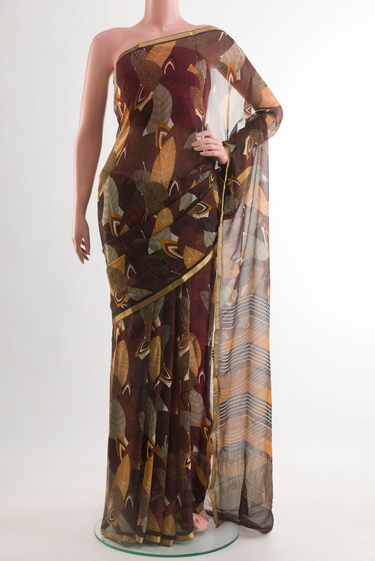 Brown Mysore Chiffon Saree with Printed design on the body and Zari Border.  displayed on a mannequin