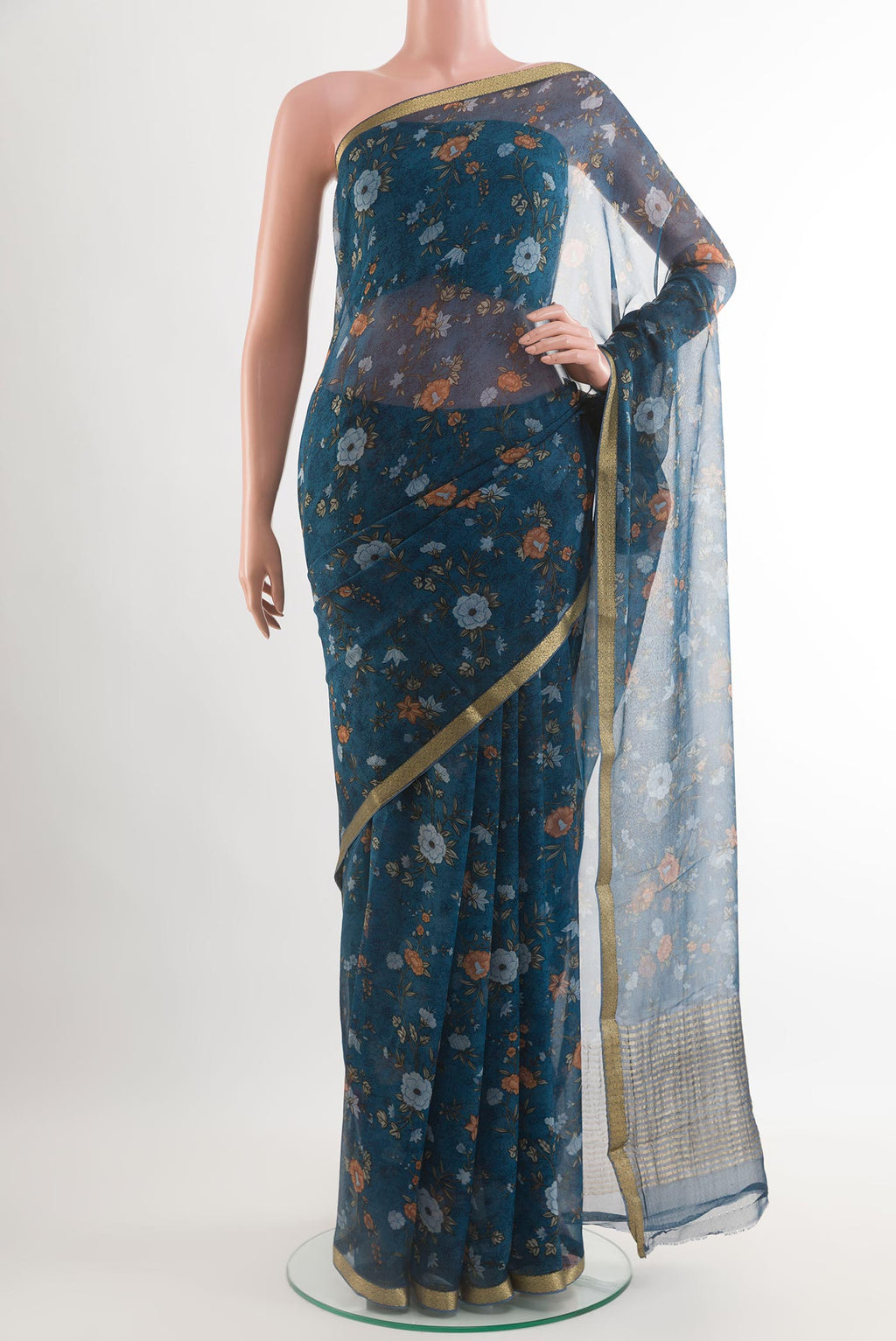 Blue Chiffon Saree with Printed design on the body and Plain Border.  displayed on a mannequin