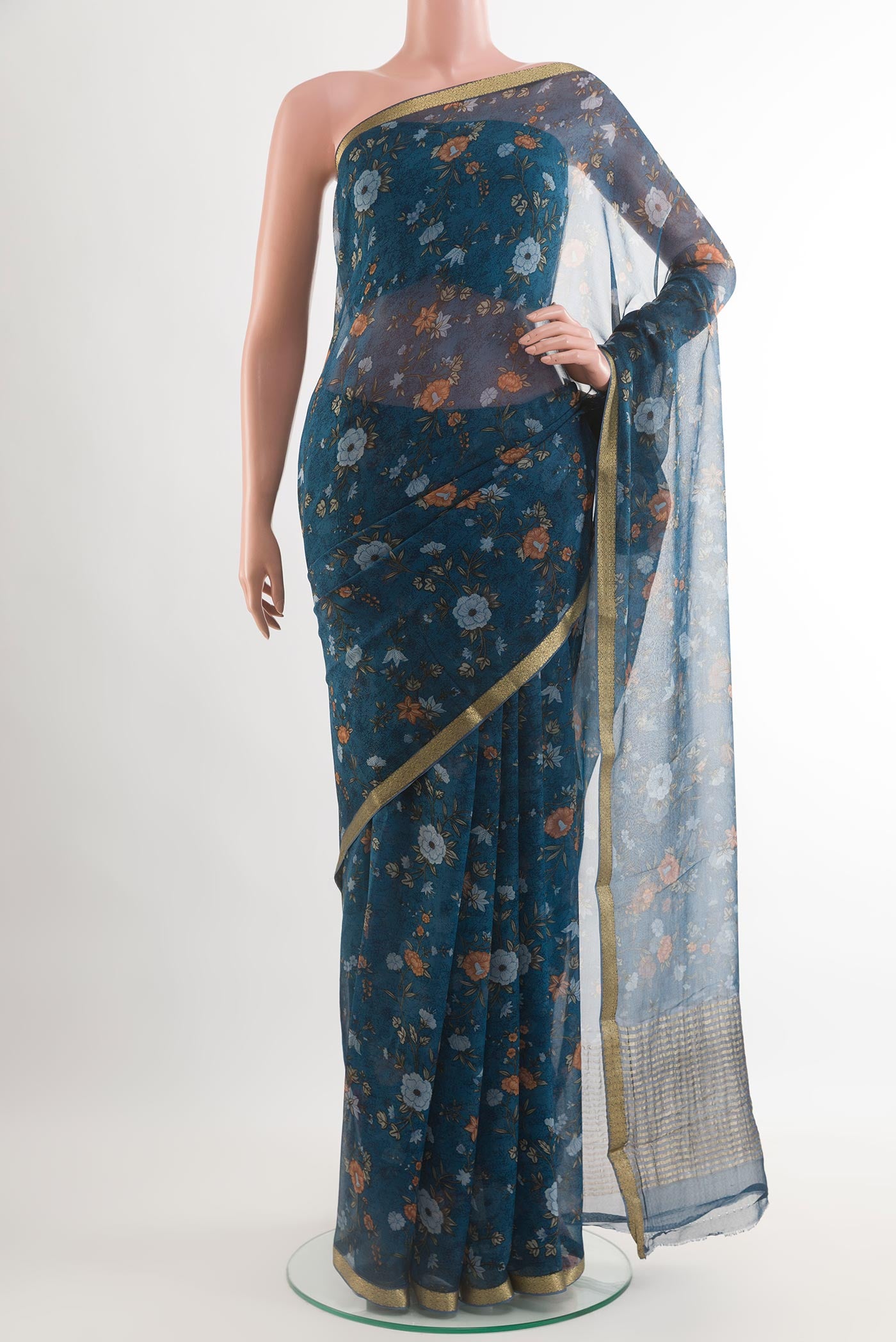 Blue Chiffon Saree with Printed design on the body and Plain Border.  displayed on a mannequin