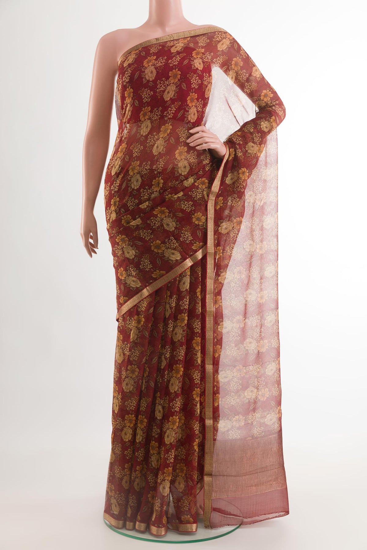 Red Chiffon Saree with Printed design on the body and Zari Border.  displayed on a mannequin