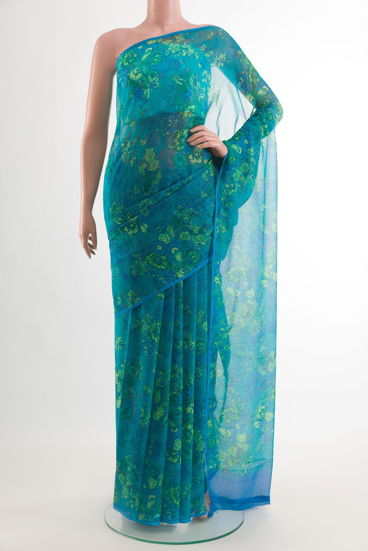 Blue Chiffon Saree with Printed design on the body and Plain Border.  displayed on a mannequin