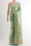 Sea Green Kanjivaram Tissue Silk Saree with Zari Butta on the body and Embroidery Border.  displayed on a mannequin