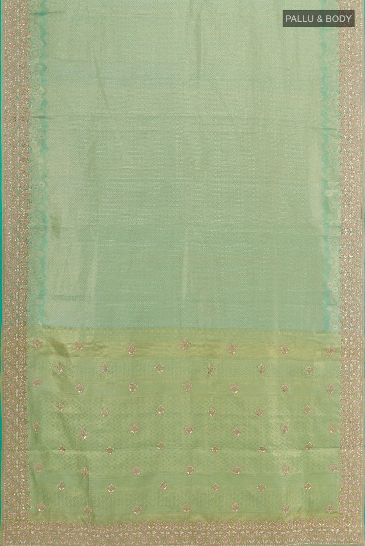 Flat view of Sea Green Kanjivaram Tissue Silk Saree with Zari Butta on the body and Embroidery Border. 