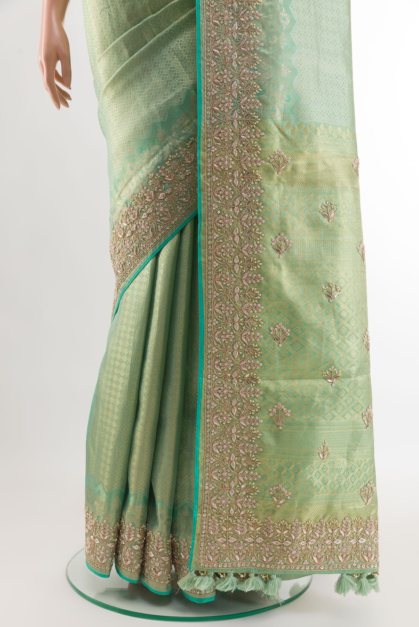 Pleats and pallu of Sea Green Kanjivaram Tissue Silk Saree with Zari Butta on the body and Embroidery Border. 