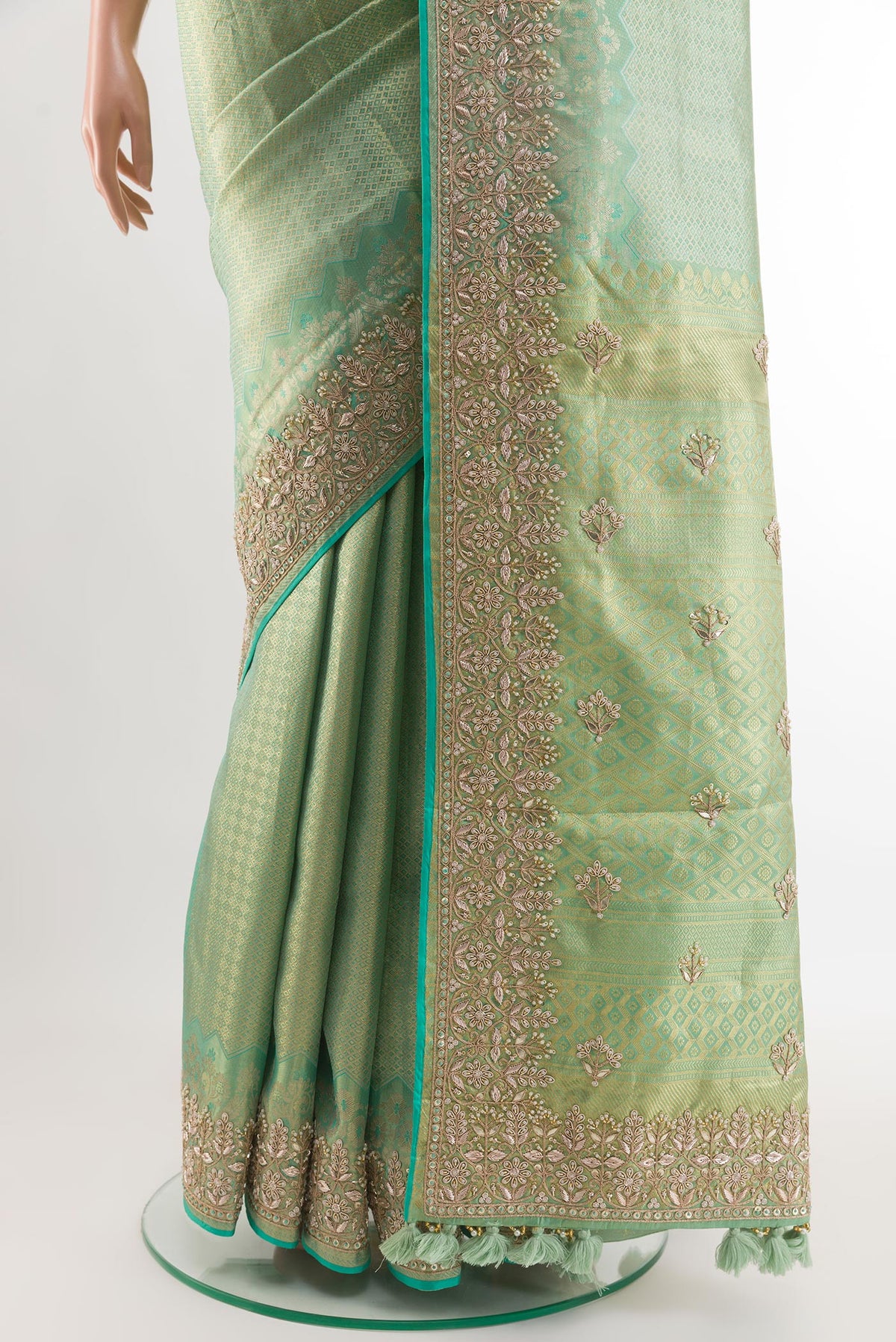 Pleats and pallu of Sea Green Kanjivaram Tissue Silk Saree with Zari Butta on the body and Embroidery Border. 