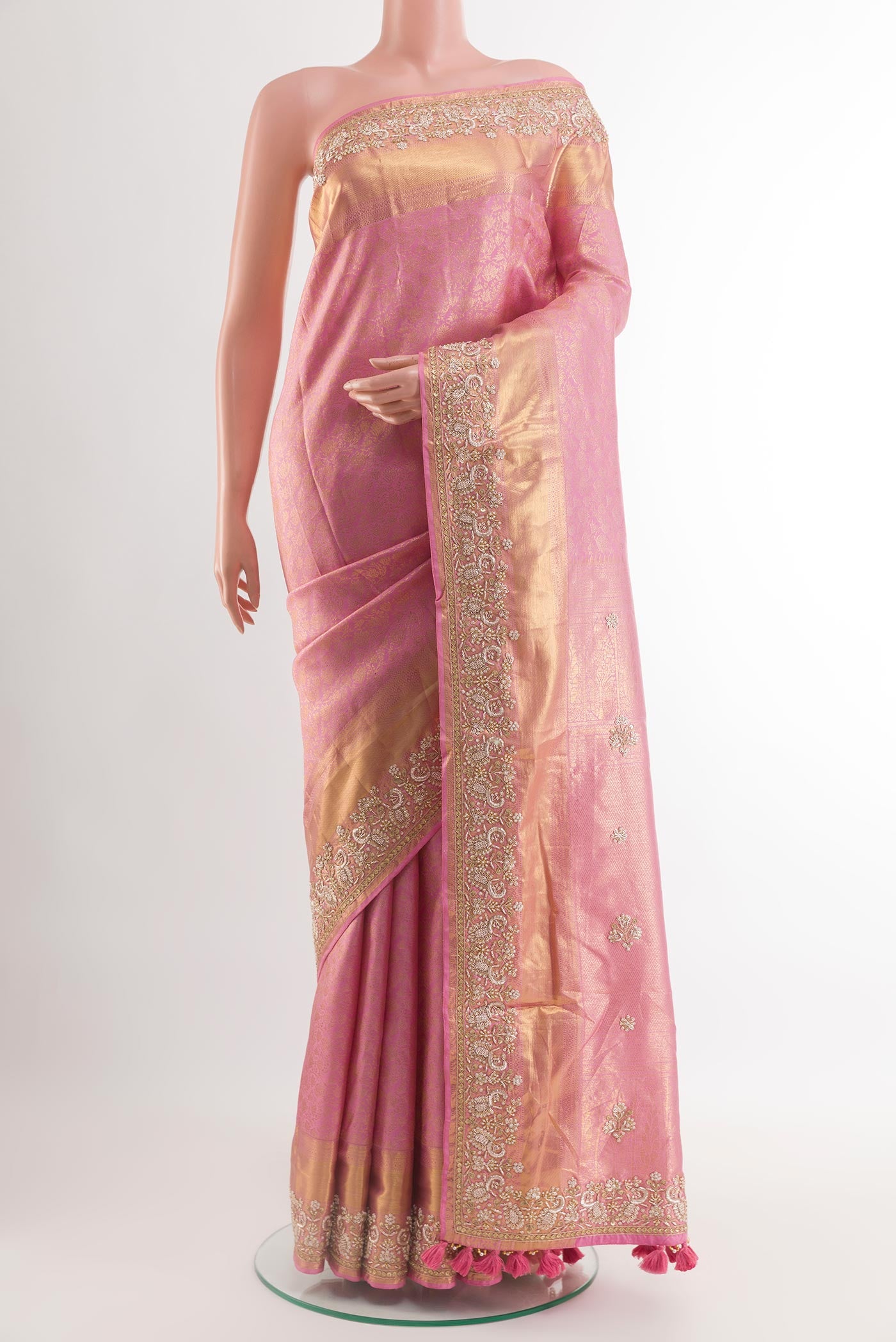Pink Kanjivaram Tissue Silk Saree with Zari Butta on the body and Embroidery Border.  displayed on a mannequin