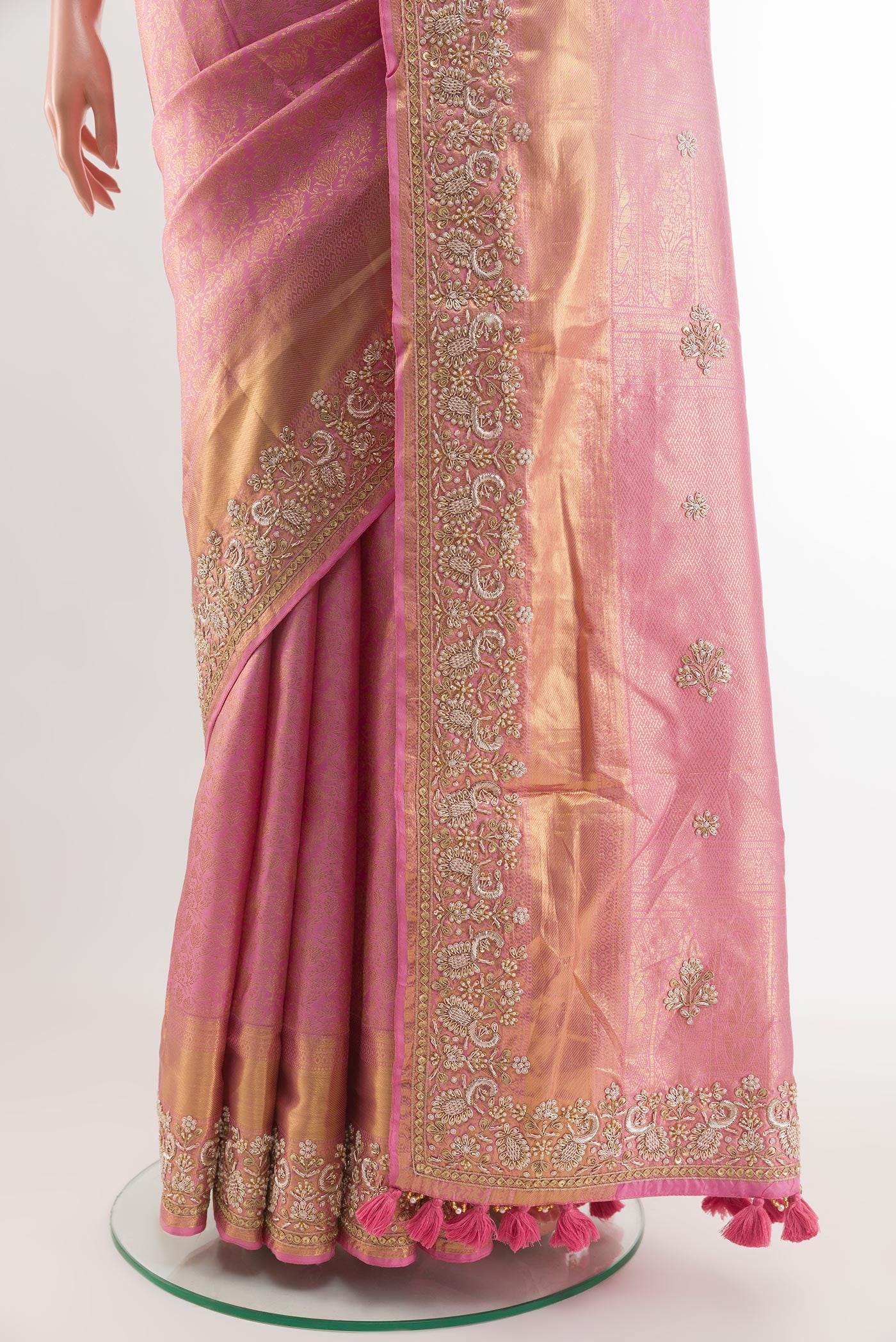 Pleats and pallu of Pink Kanjivaram Tissue Silk Saree with Zari Butta on the body and Embroidery Border. 