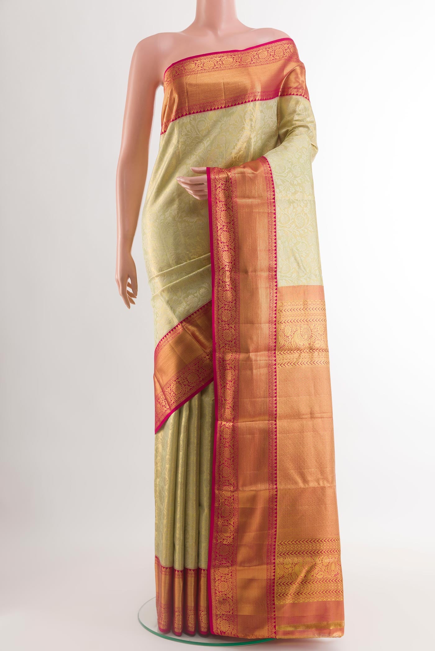 Light Green Kanjivaram Silk Saree with Zari Brocade on the body and Zari Border.  displayed on a mannequin