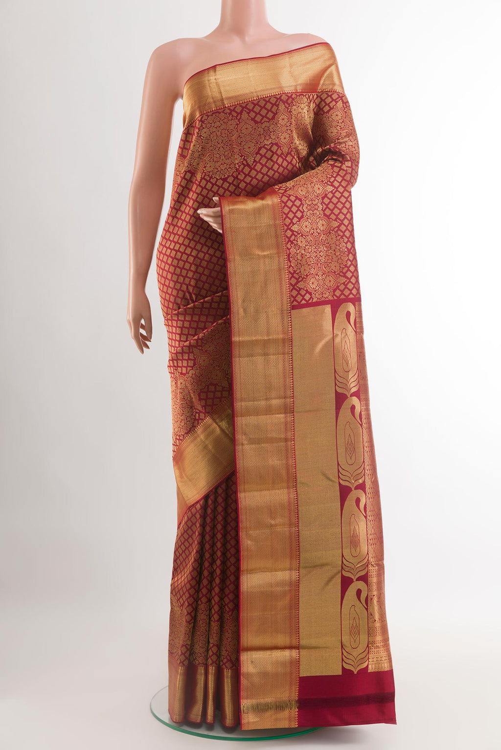 Maroon Kanjivaram Silk Saree with Zari Brocade on the body and Zari Border.  displayed on a mannequin