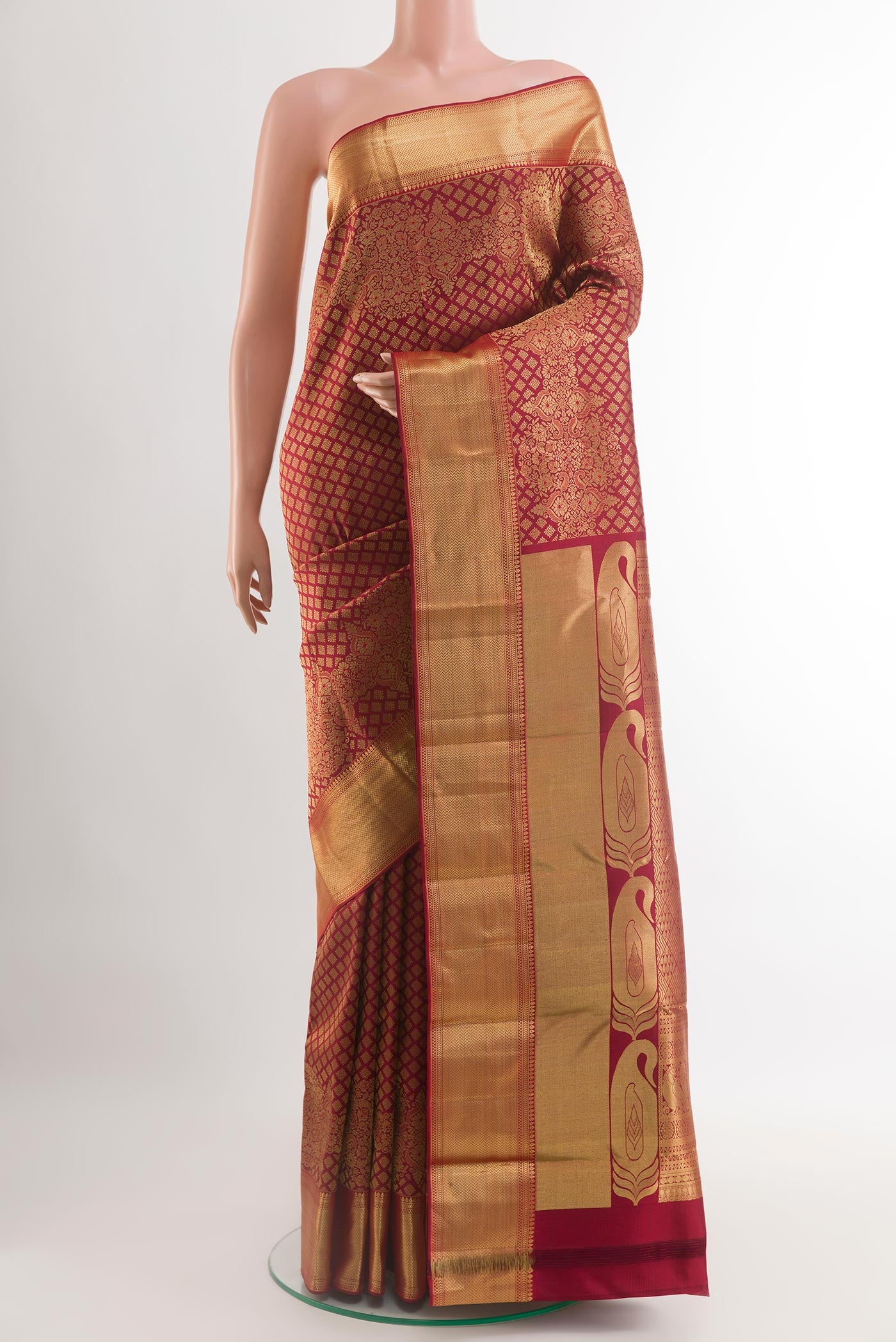 Maroon Kanjivaram Silk Saree with Zari Brocade on the body and Zari Border.  displayed on a mannequin