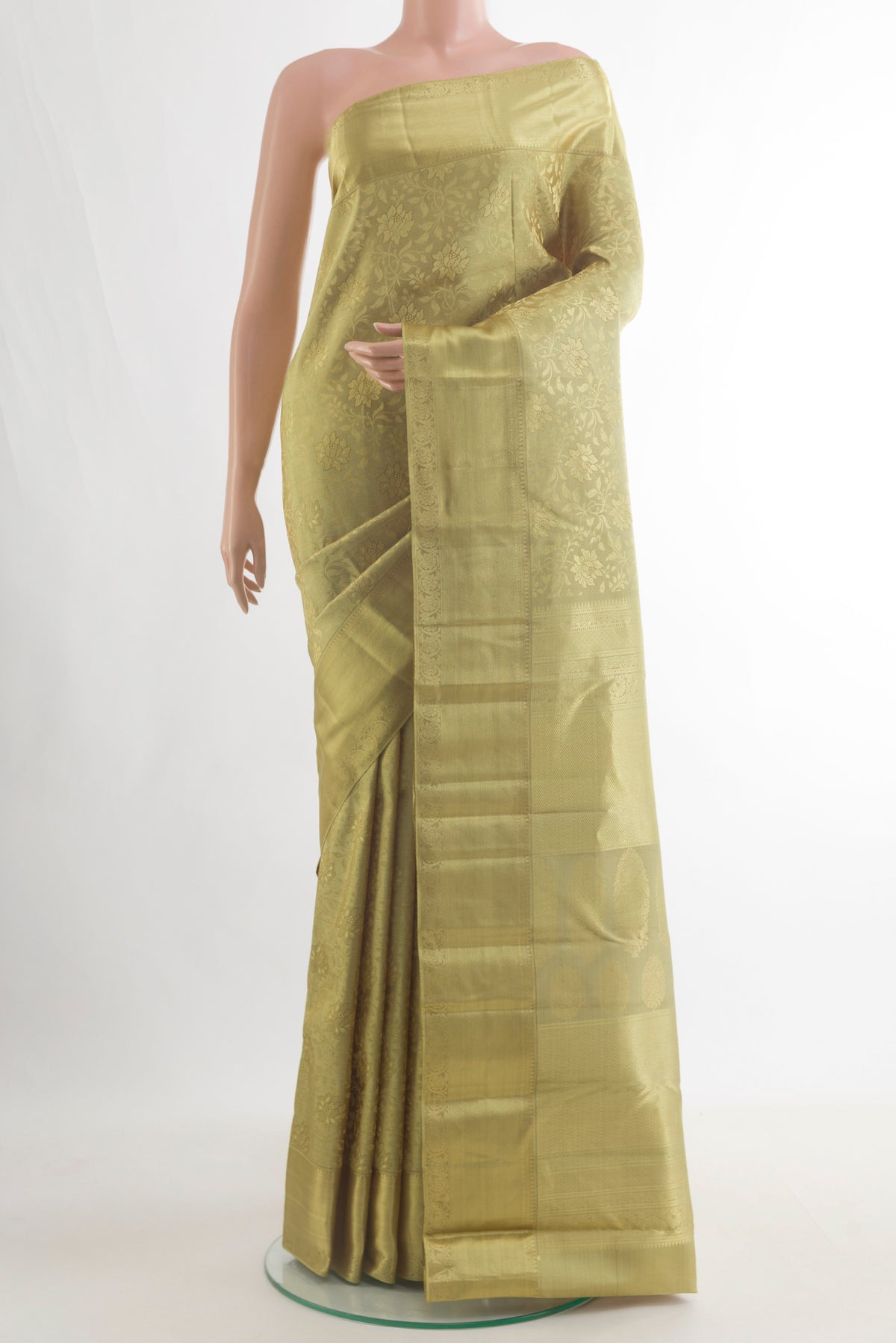 Pure Silk Green Kanjivaram Saree with Zari Brocade on the body and Zari Border.  displayed on a mannequin