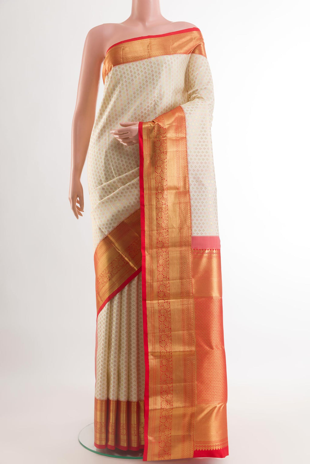 Off White Kanjivaram Silk Saree with Zari Butta on the body and Zari Border.  displayed on a mannequin