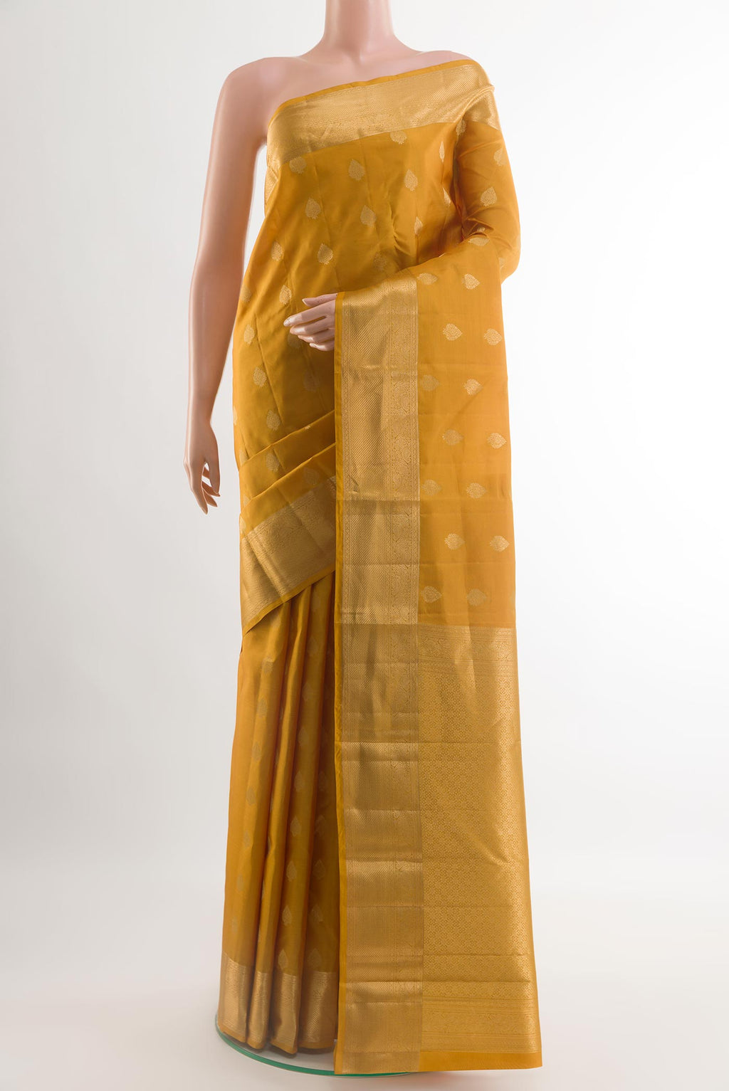 Yellow Kanchipuram Silk Saree with Zari Butta on the body and Zari Border.  displayed on a mannequin