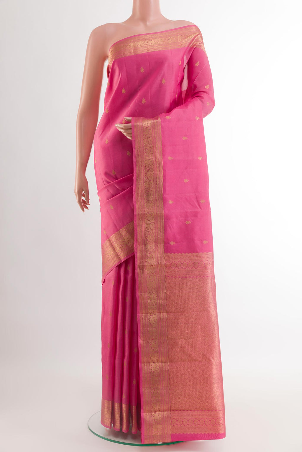 Pink Kanchipuram Silk Saree with Zari Butta on the body and Zari Border.  displayed on a mannequin