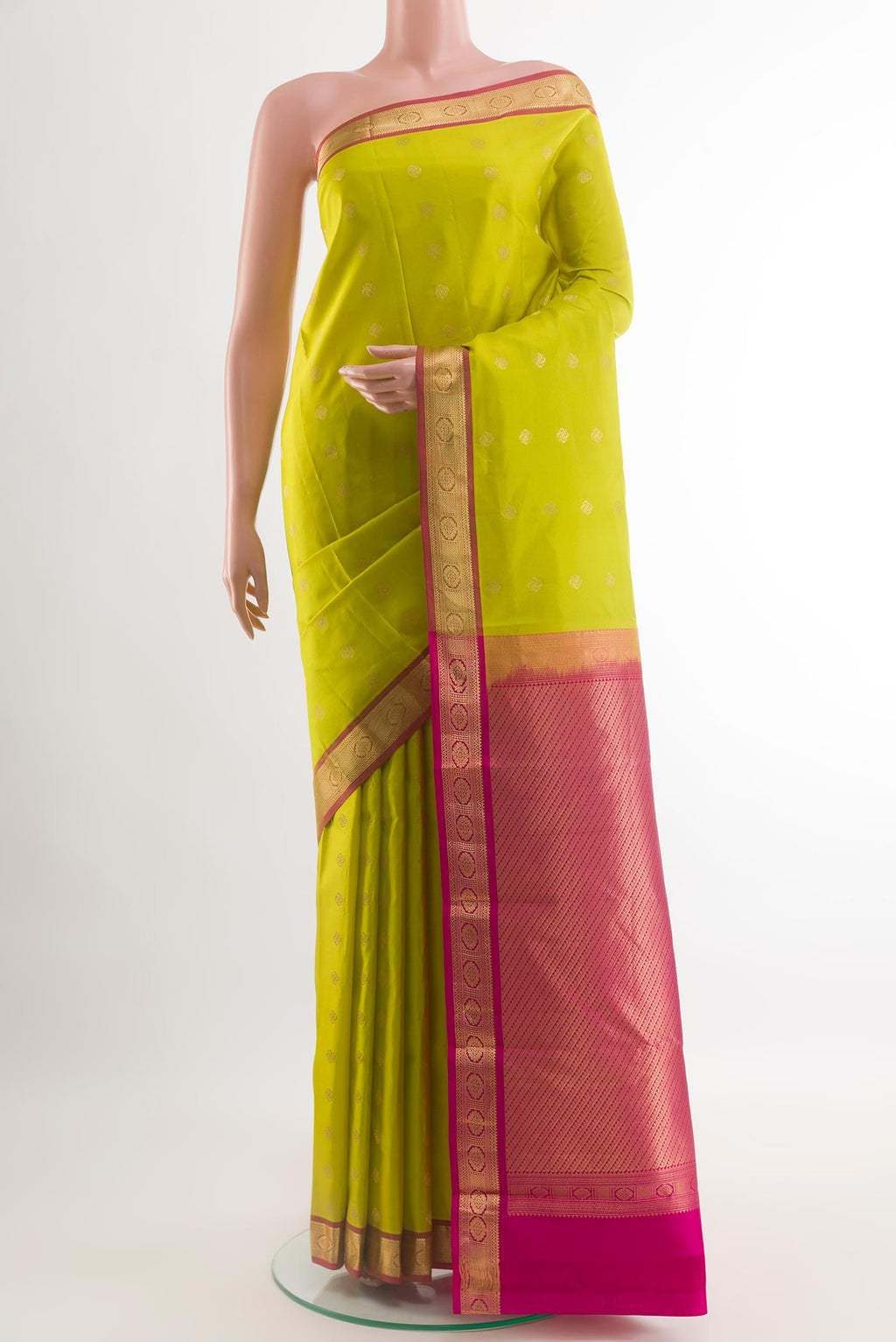 Green Kanchipuram Silk Saree with Zari Butta on the body and Zari Border.  displayed on a mannequin