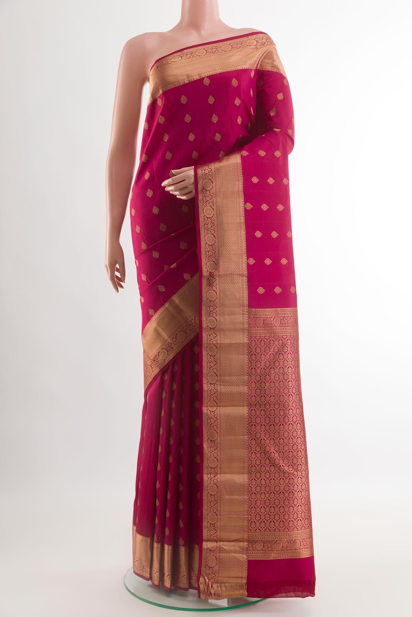 Maroon Kanchipuram Silk Saree with Zari Butta on the body and Zari Border.  displayed on a mannequin