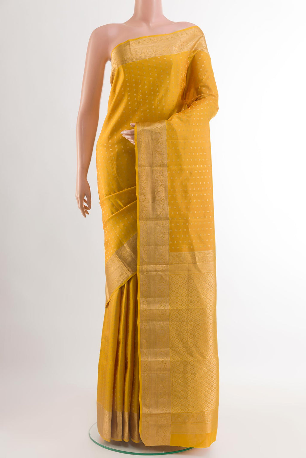 Yellow Kanchipuram Silk Saree with Zari Butta on the body and Zari Border.  displayed on a mannequin