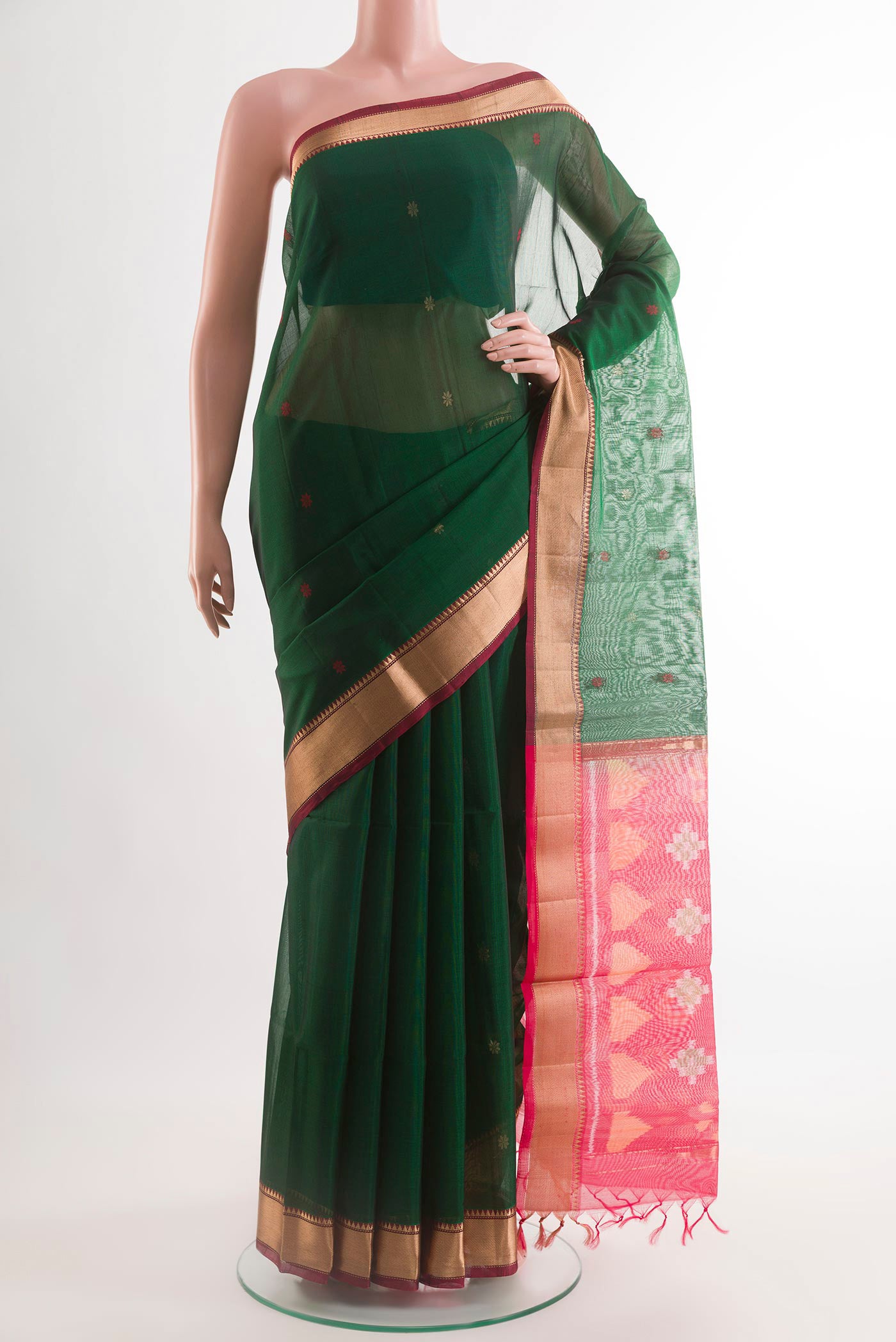 Green Kora Cotton Saree with Zari Butta on the body and Zari Border.  displayed on a mannequin
