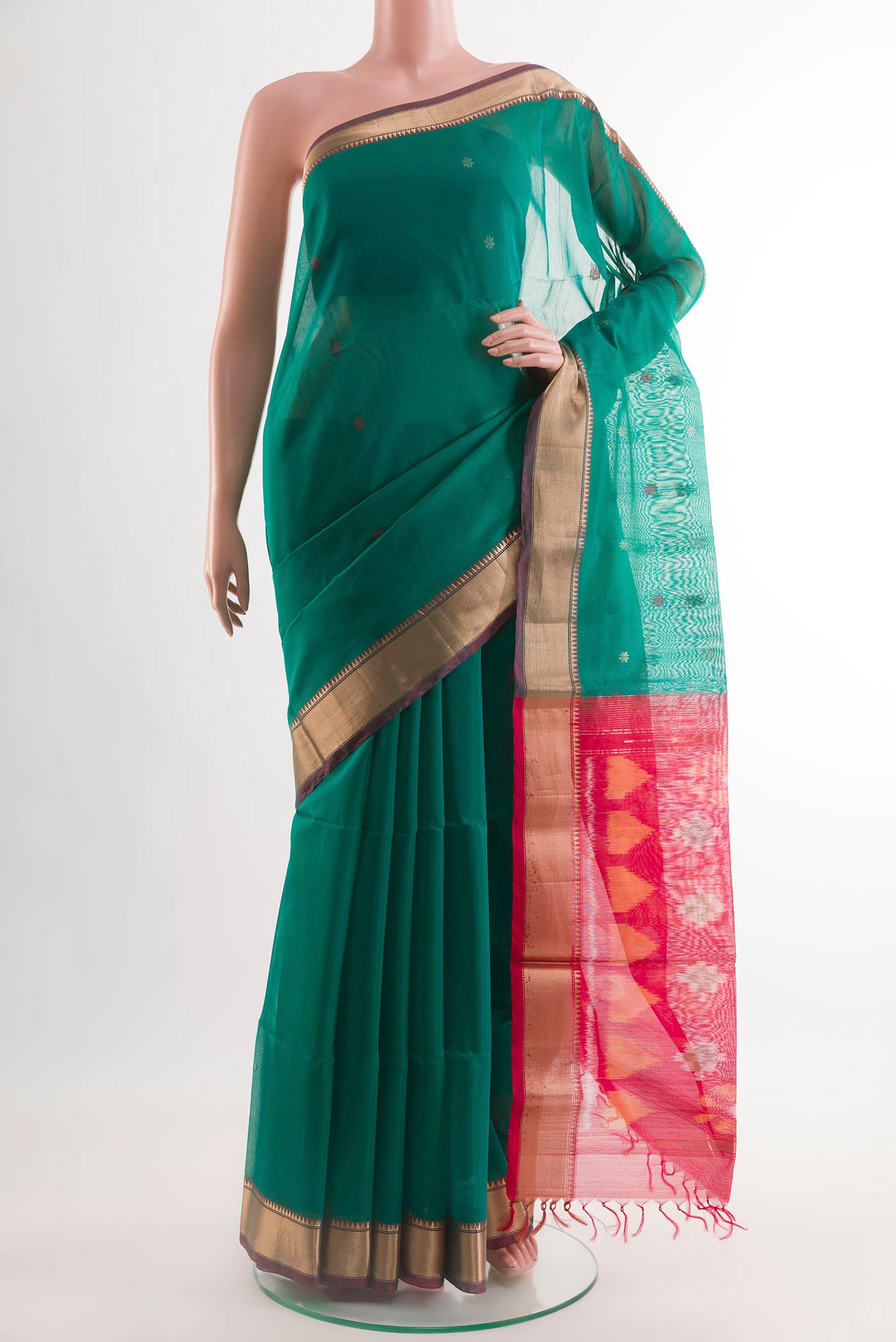 Green Blended Kora Cotton Saree with Zari Butta on the body and Zari Border.  displayed on a mannequin