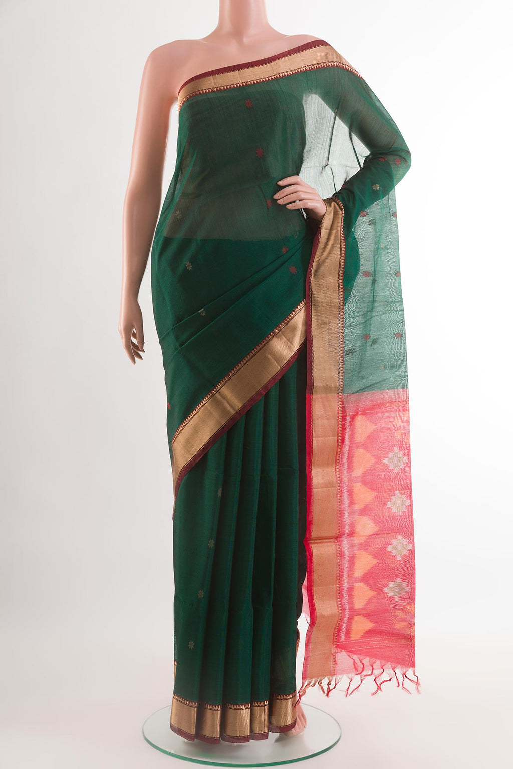 Bottle Green Blended Kora Silk Saree with Zari Butta on the body and Zari Border.  displayed on a mannequin