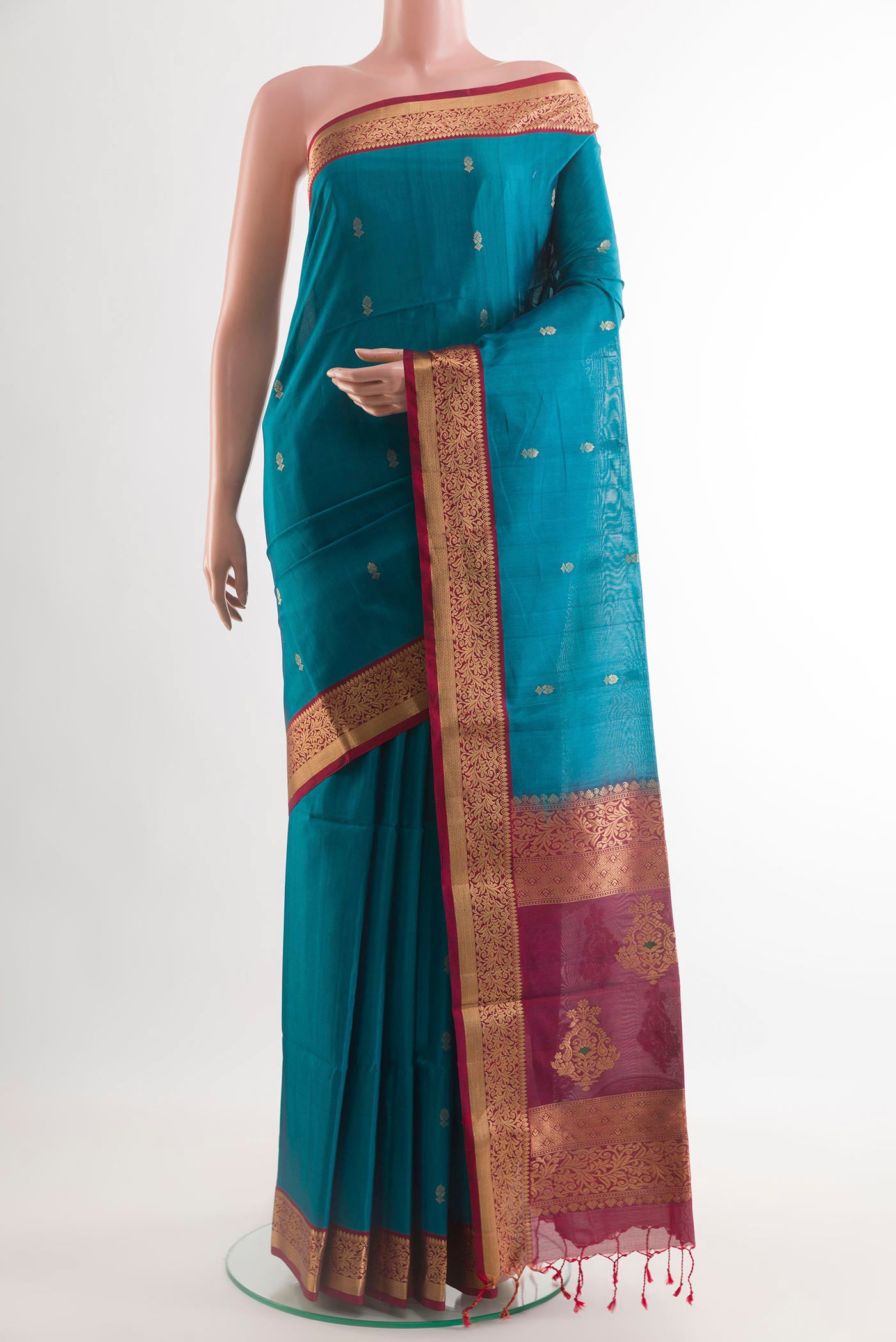 Blue Soft Silk Saree with Zari Butta on the body and Zari Border.  displayed on a mannequin