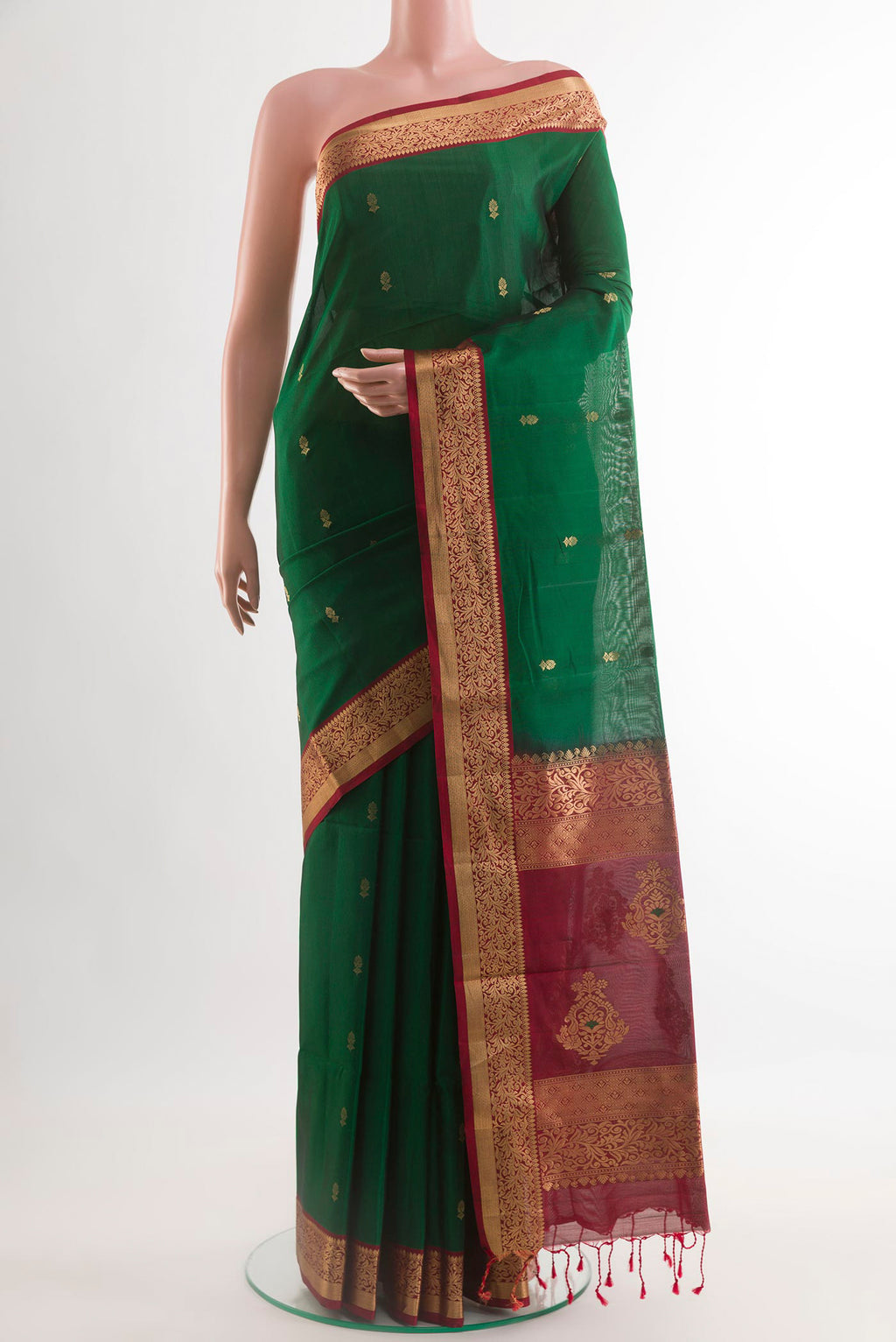 Green Soft Silk Saree with Zari Butta on the body and Zari Border.  displayed on a mannequin